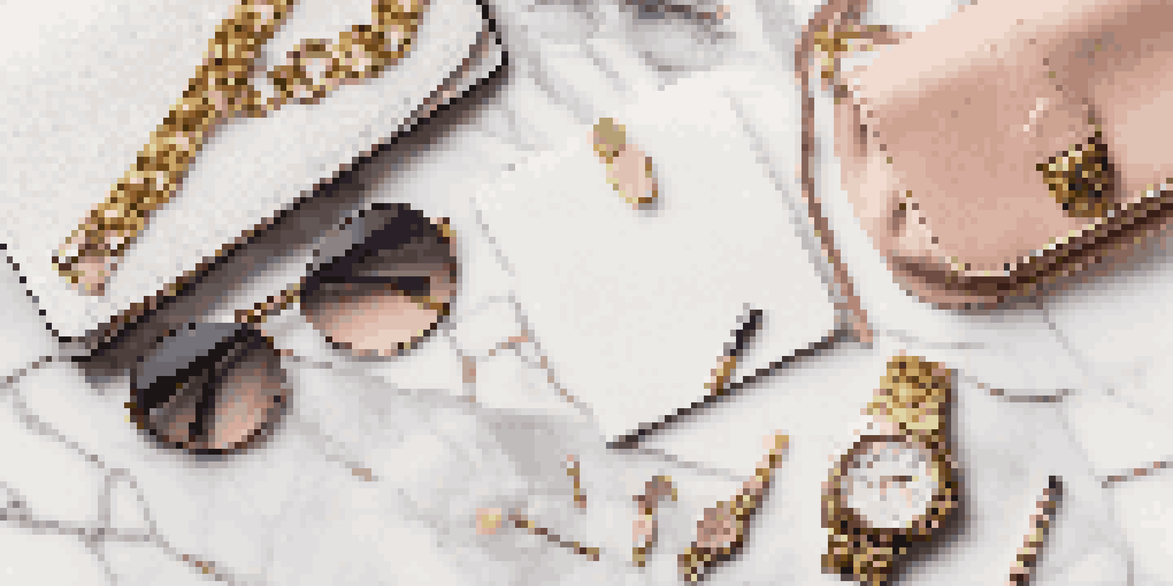 An elegant flat lay of luxury accessories including a handbag, sunglasses, watch, and notebook on a marble background, illuminated by soft natural light.