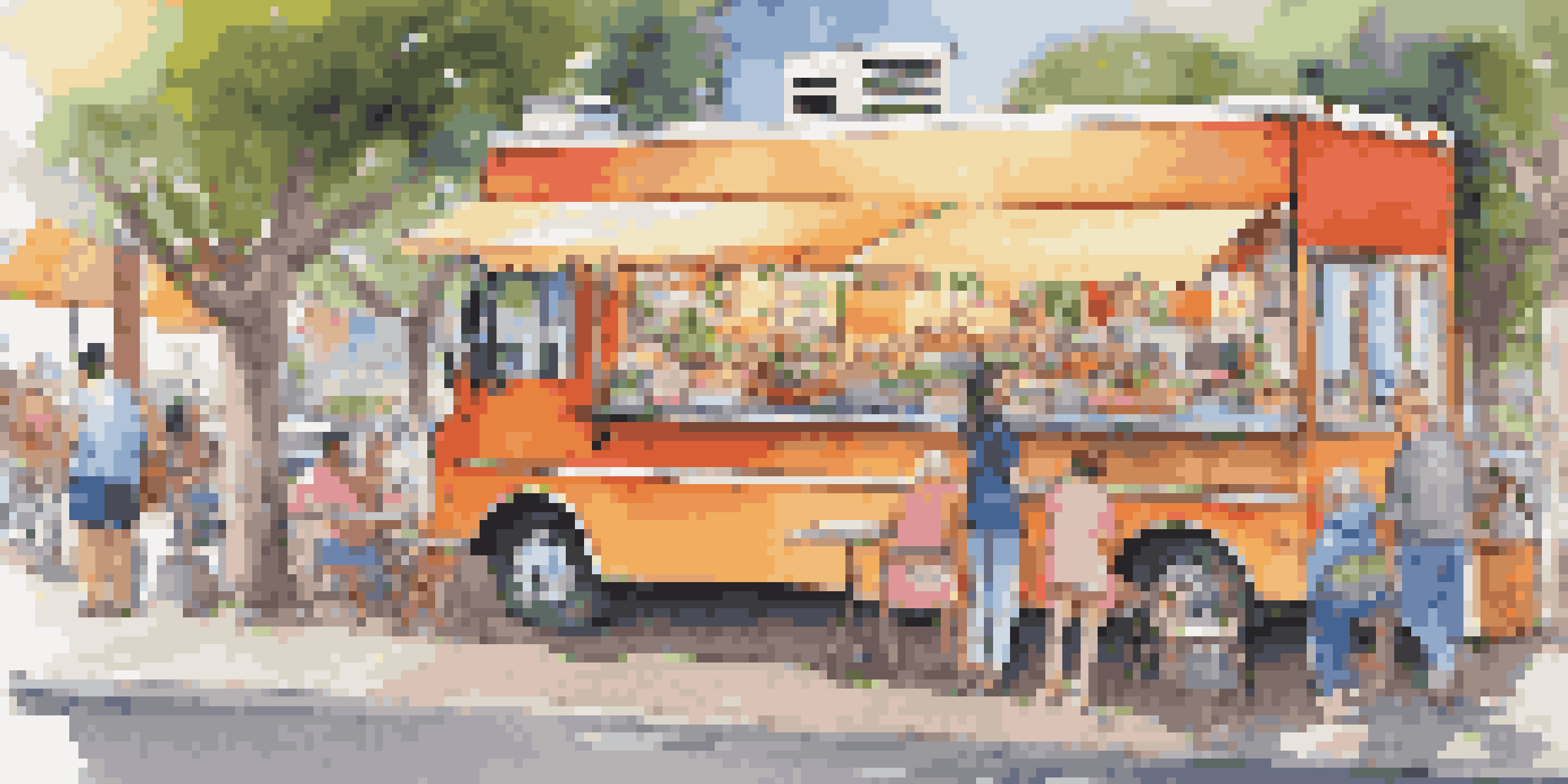 A colorful gourmet food truck with delicious dishes displayed, surrounded by happy customers dining at picnic tables.