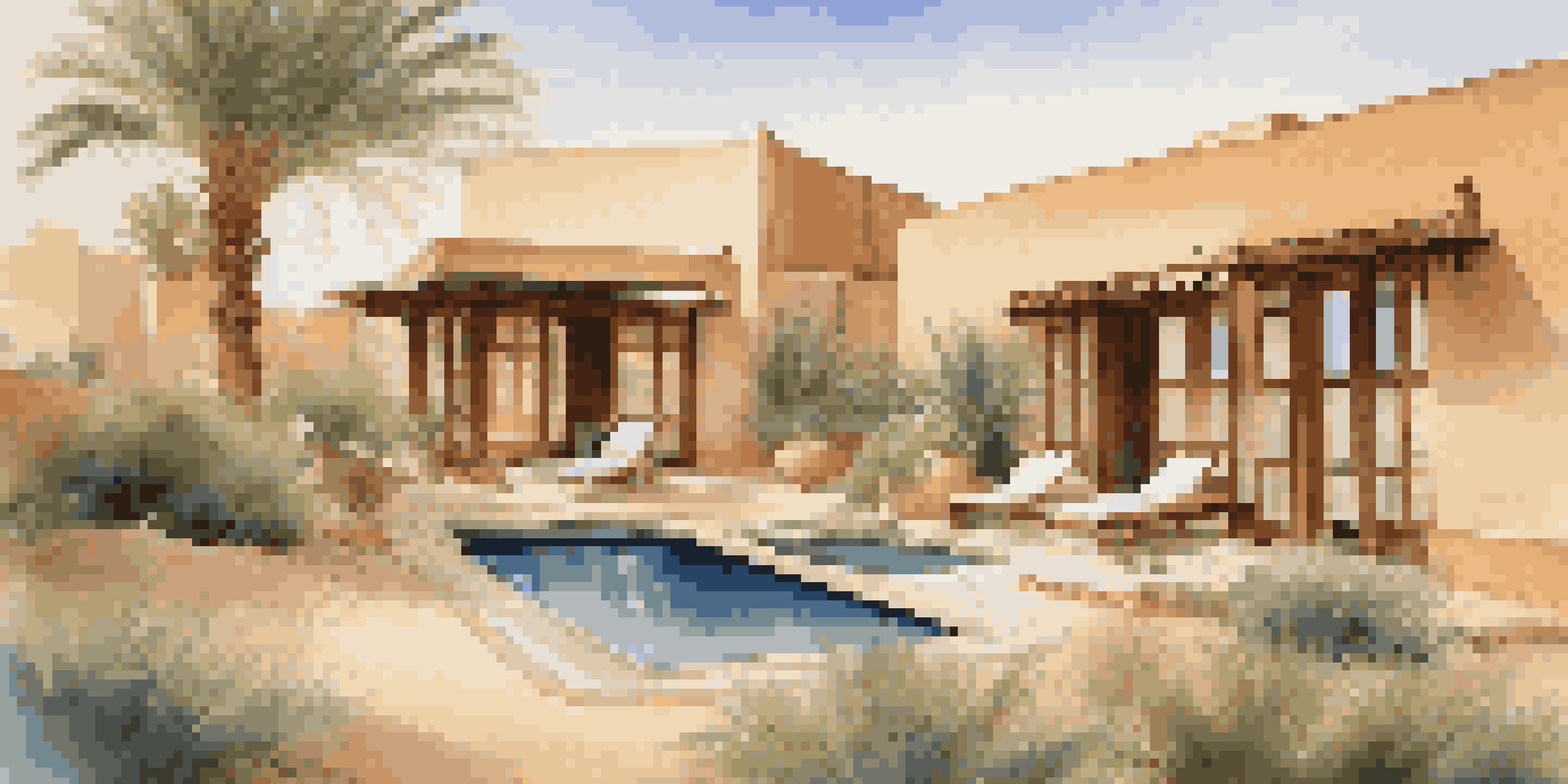 A luxury villa with a plunge pool in the Dubai Desert, showcasing traditional Bedouin architecture and beautiful sunset views.