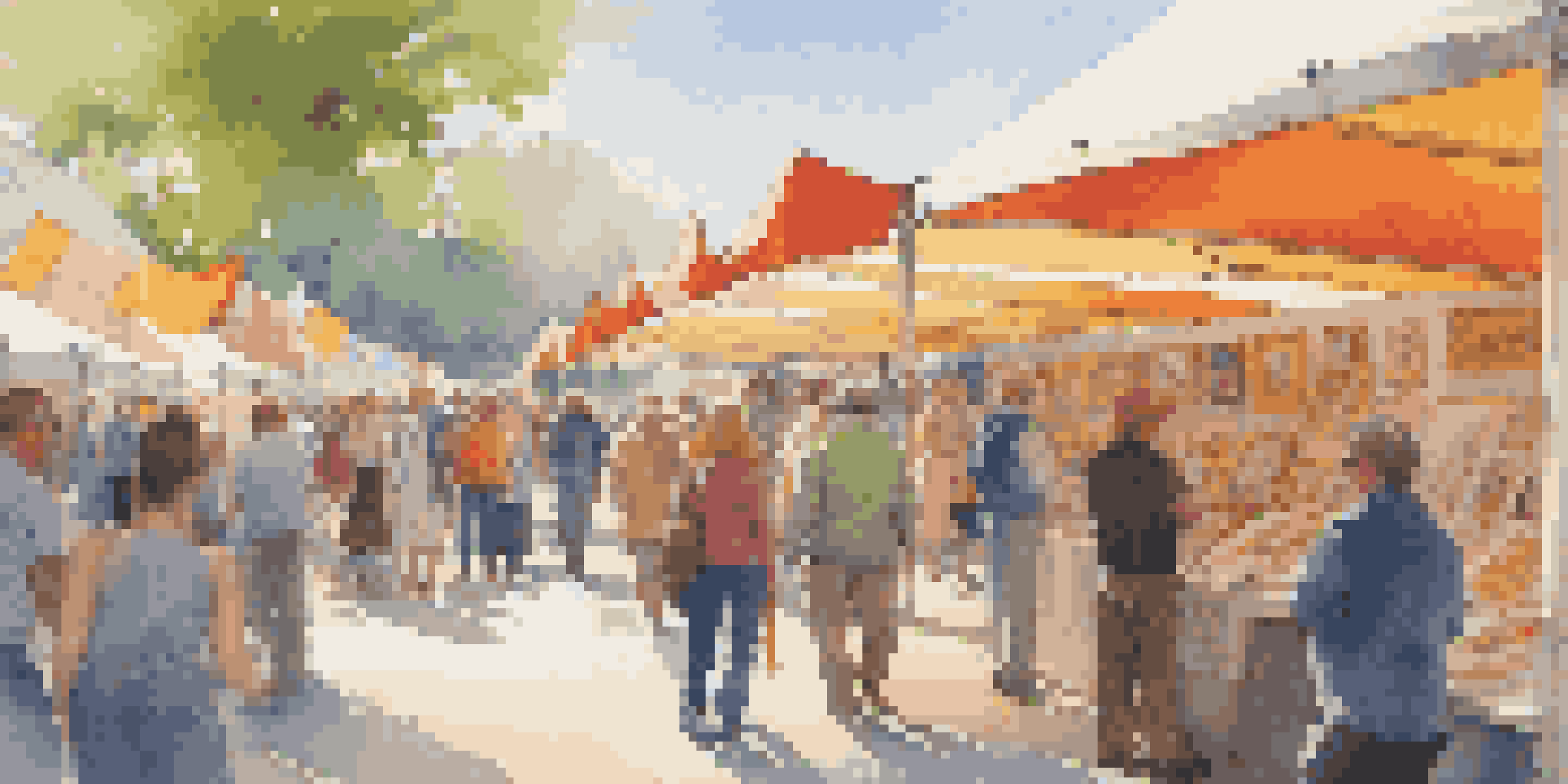 A busy art fair with colorful booths displaying artwork and people interacting with artists.