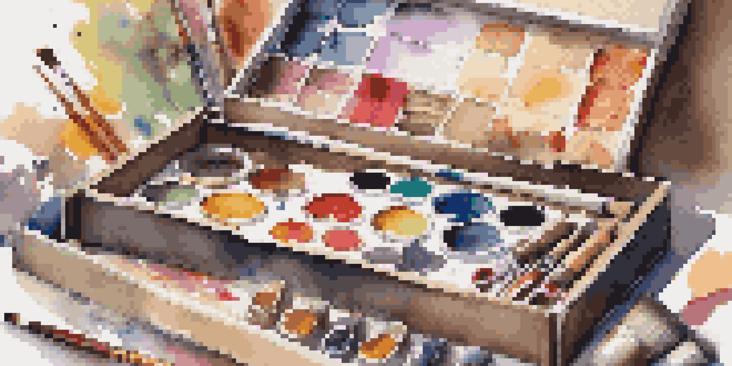 An opened subscription box displaying a variety of premium art supplies like paints and brushes in a cozy artist's studio.