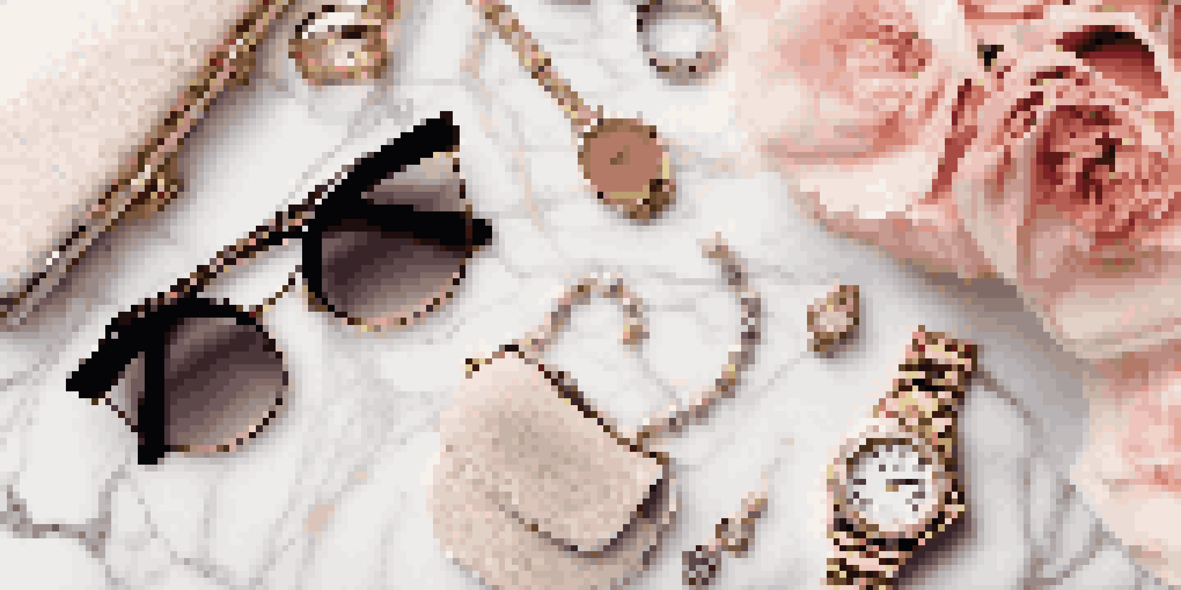 A flat lay of luxury fashion accessories on a marble surface, including a handbag, sunglasses, and flowers, illuminated by soft natural light.