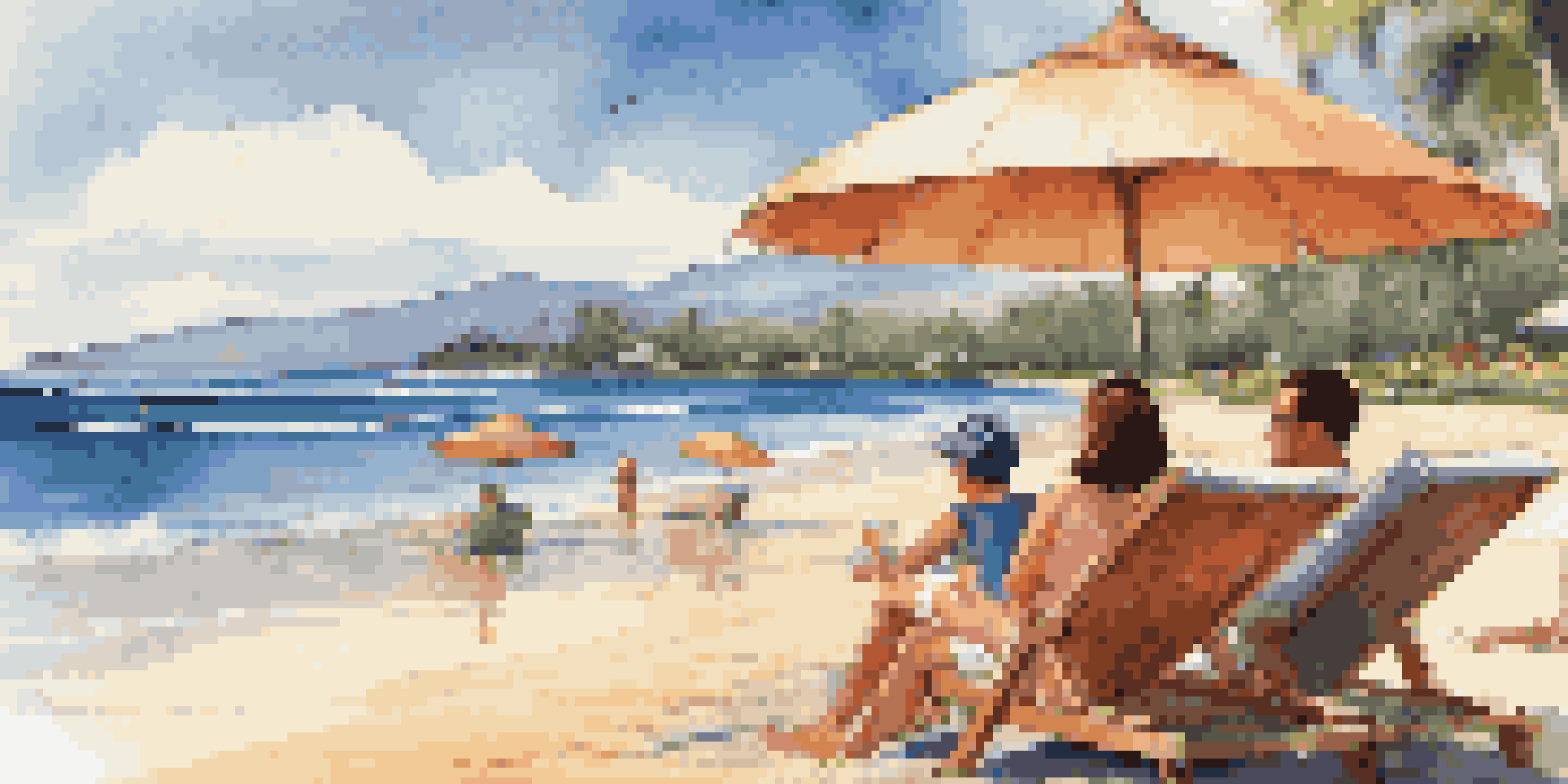 A family enjoying a day at the beach in Maui, with parents relaxing in lounge chairs and children playing in the sand.