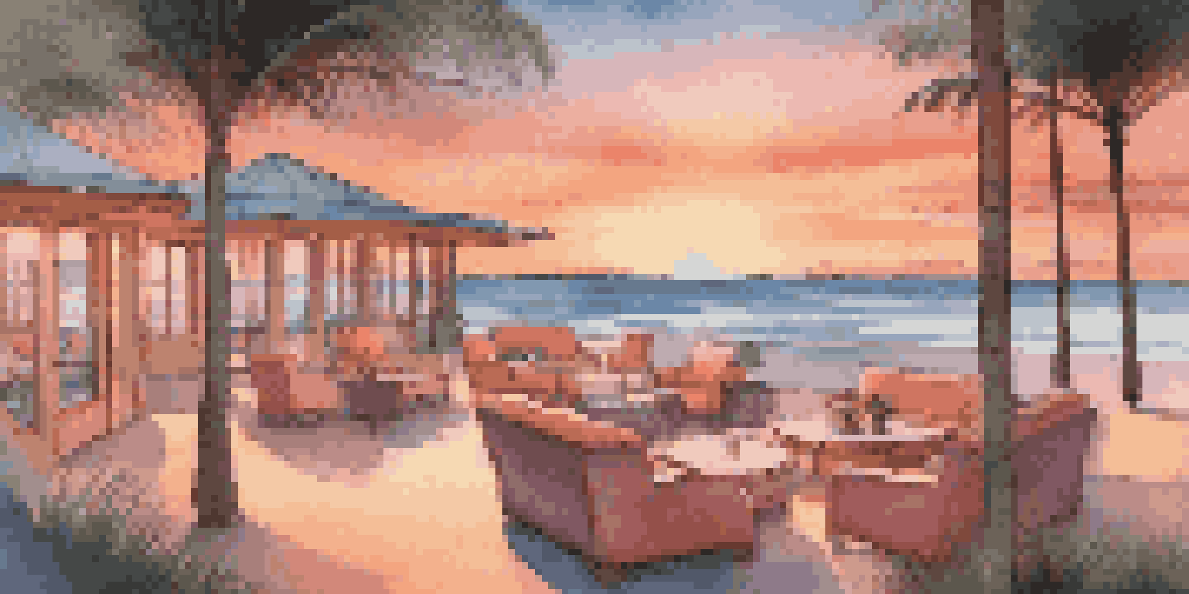 A peaceful beachfront resort at sunset, featuring a cozy meeting space with lounge seating and palm trees.