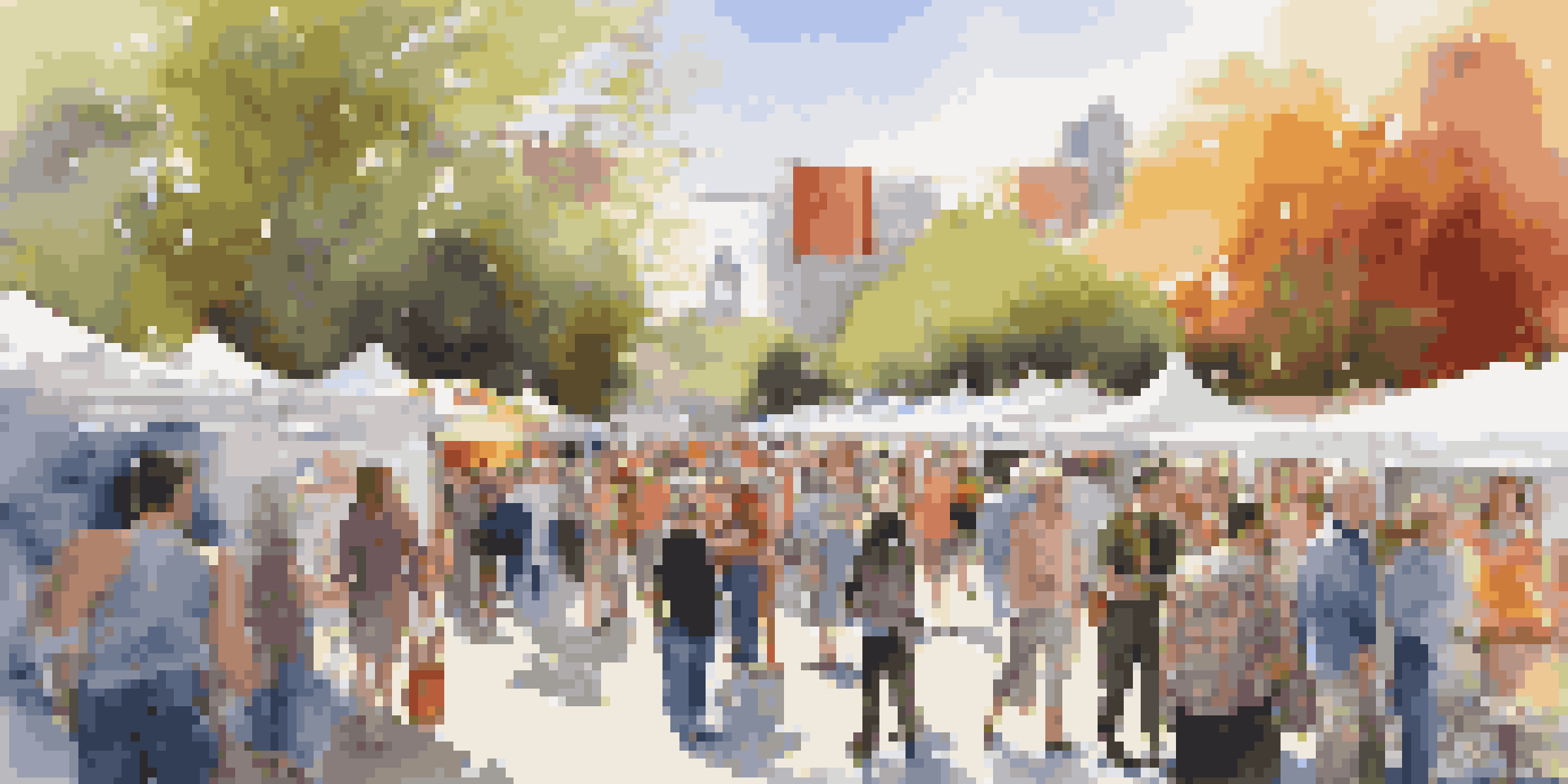 A busy art fair showcasing various artworks and engaging attendees in a lively outdoor setting.