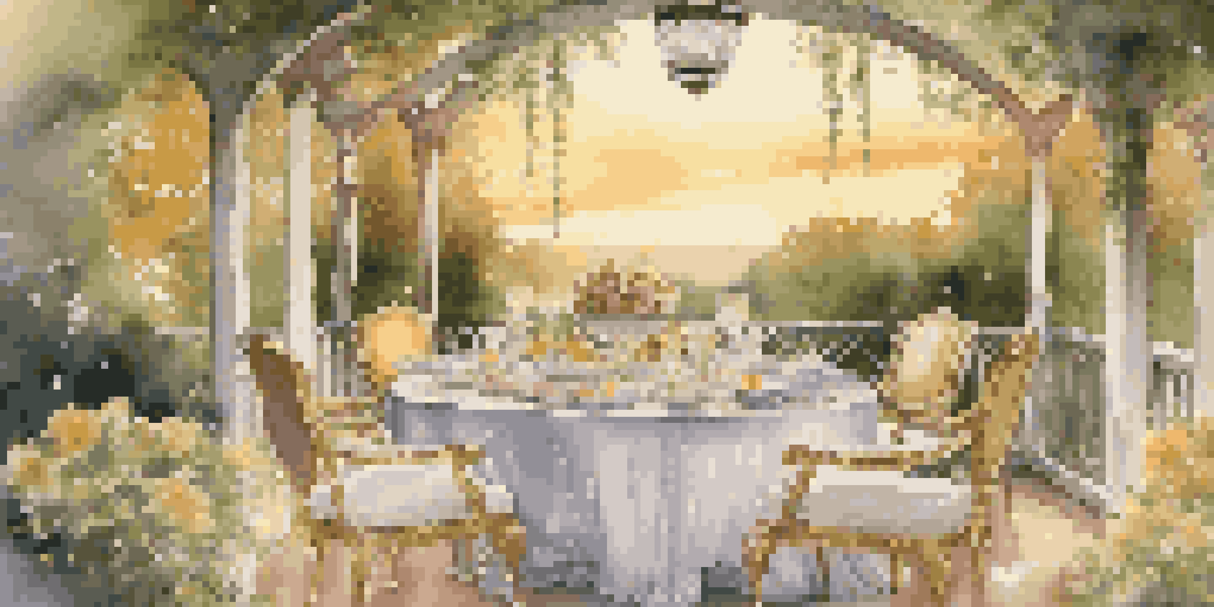 An outdoor dining table elegantly set with fine china and crystal glassware, surrounded by a lush garden at sunset.
