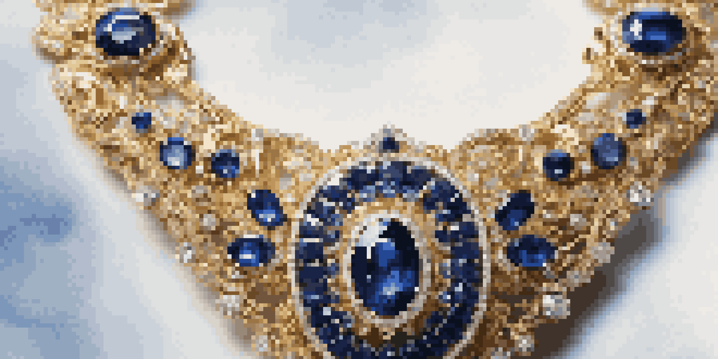A close-up view of a luxury sapphire necklace on a velvet background, showcasing the gemstone's brilliance and intricate gold design.