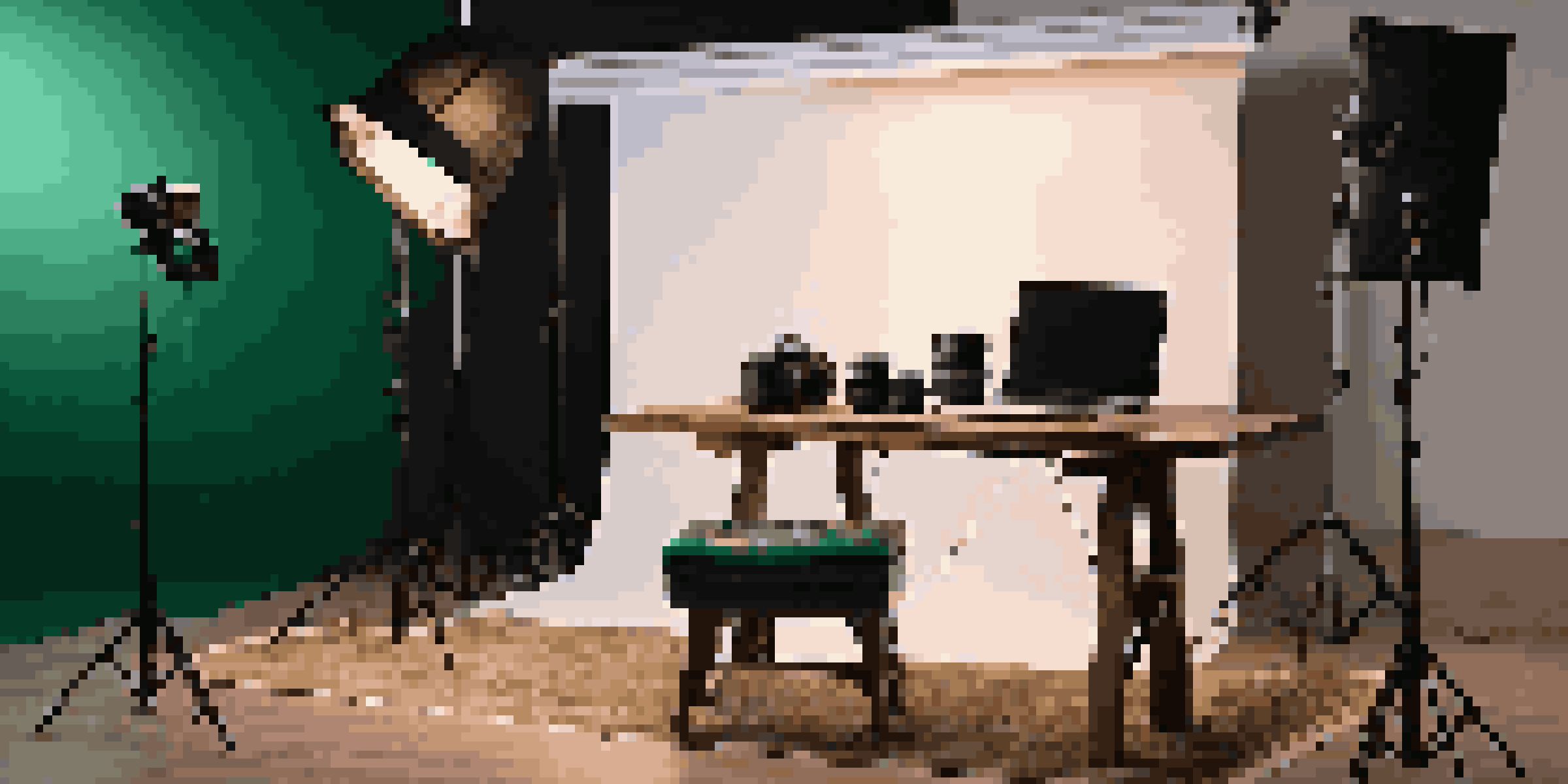 A luxurious photography studio with a modern camera on a wooden table, surrounded by high-end accessories and warm lighting.