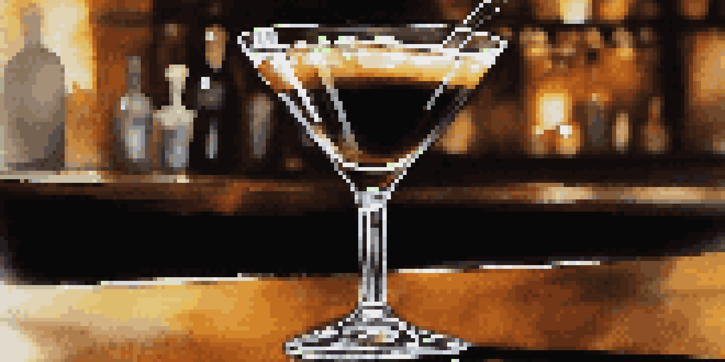 An Espresso Martini cocktail in a chilled glass, garnished with coffee beans, on a wooden table in a cozy bar setting.