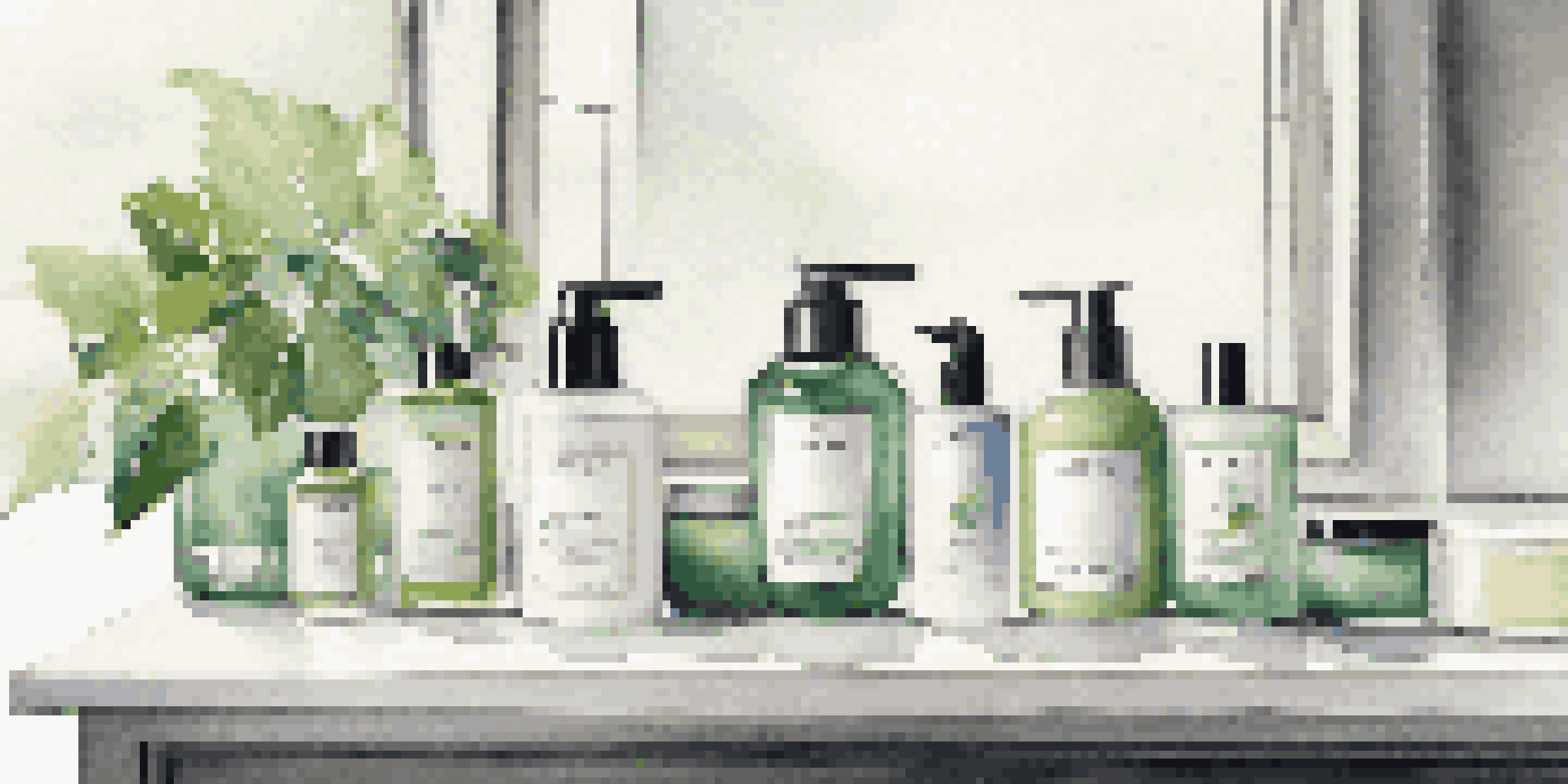 A stylish bathroom countertop displaying luxury men's skincare products, illuminated by natural light.