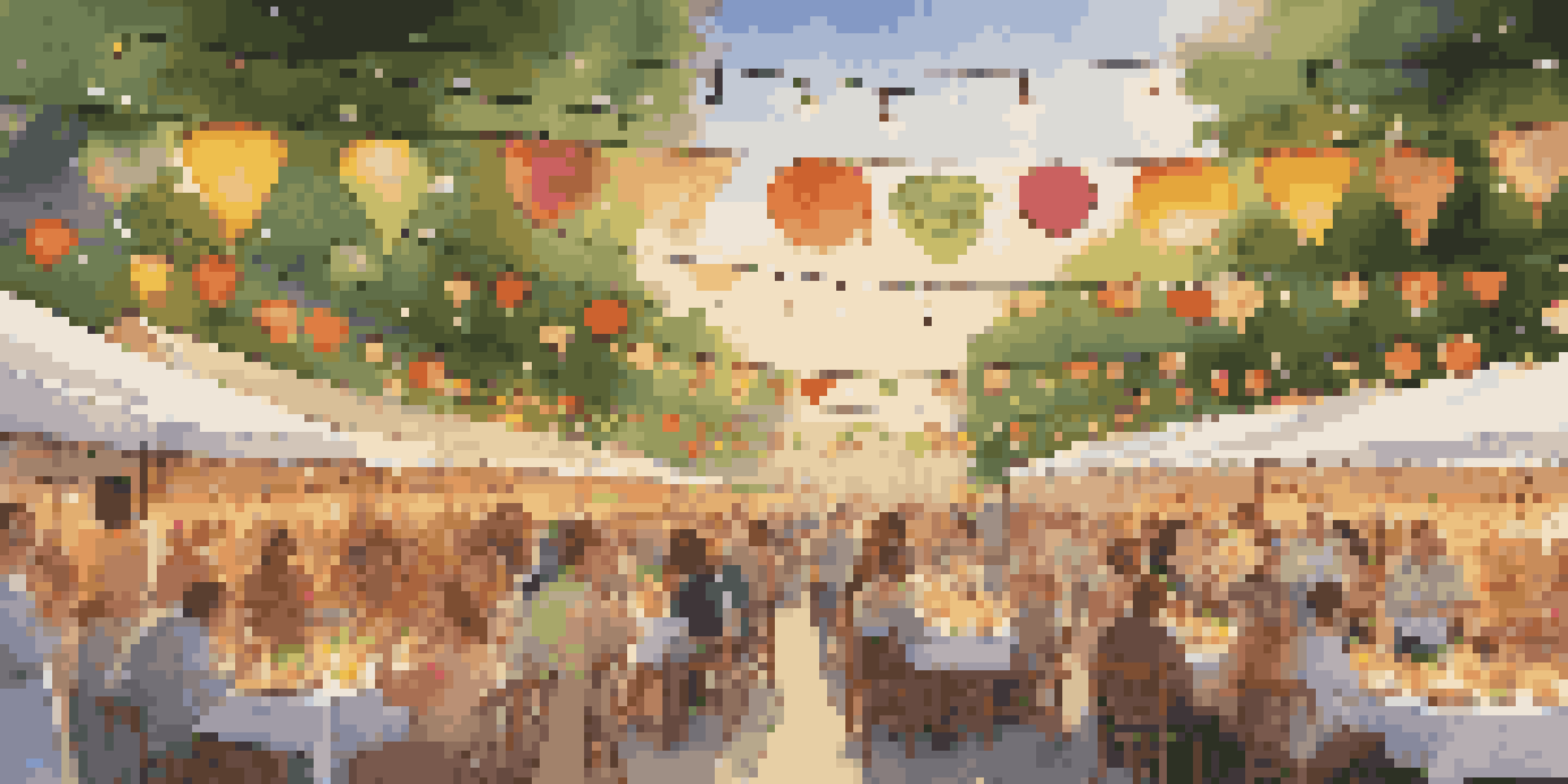 A lively culinary festival with a communal table full of gourmet dishes, surrounded by happy guests under twinkling lights.