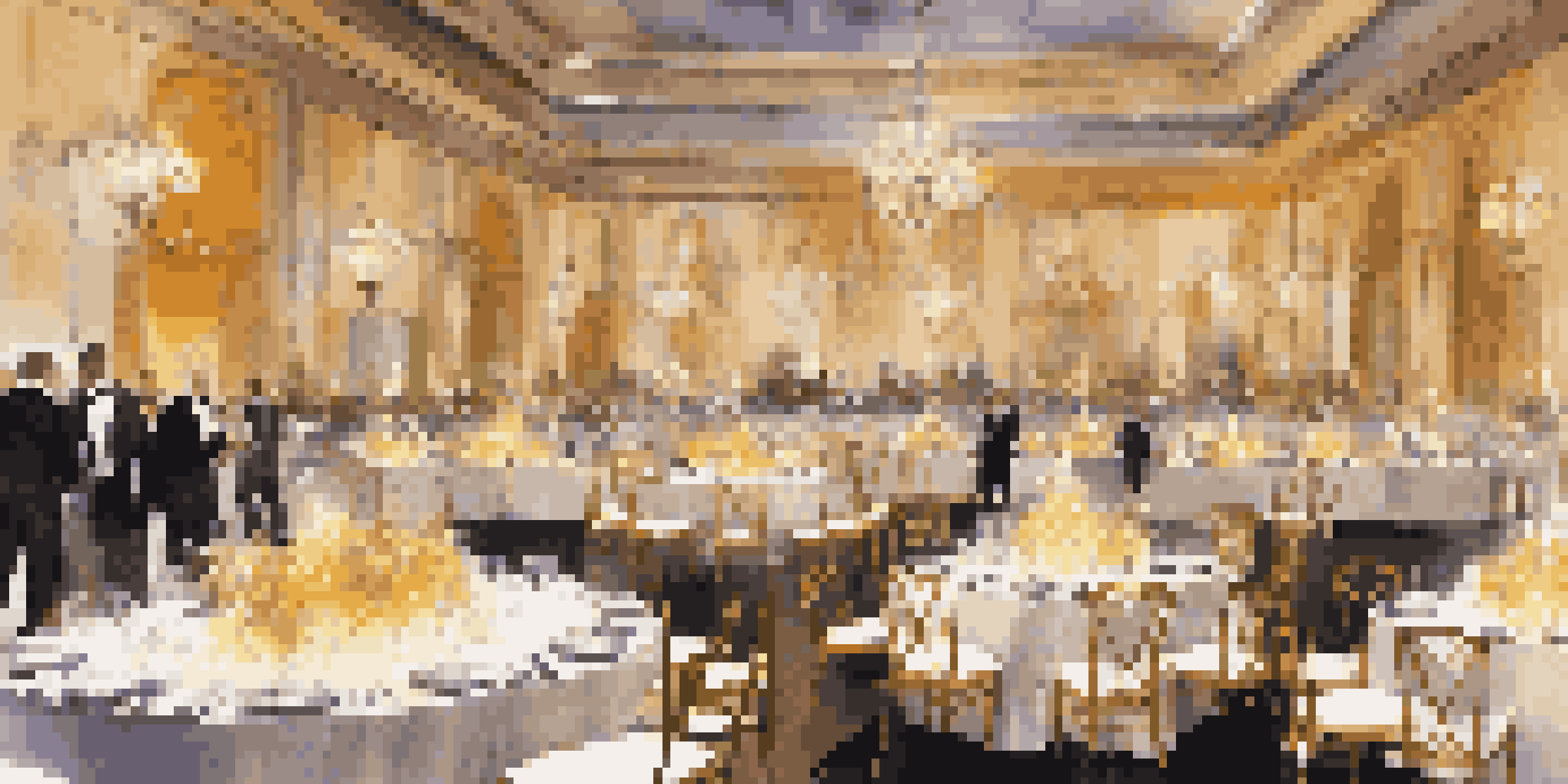 An elegant charity gala event space with decorated tables and guests in formal attire.