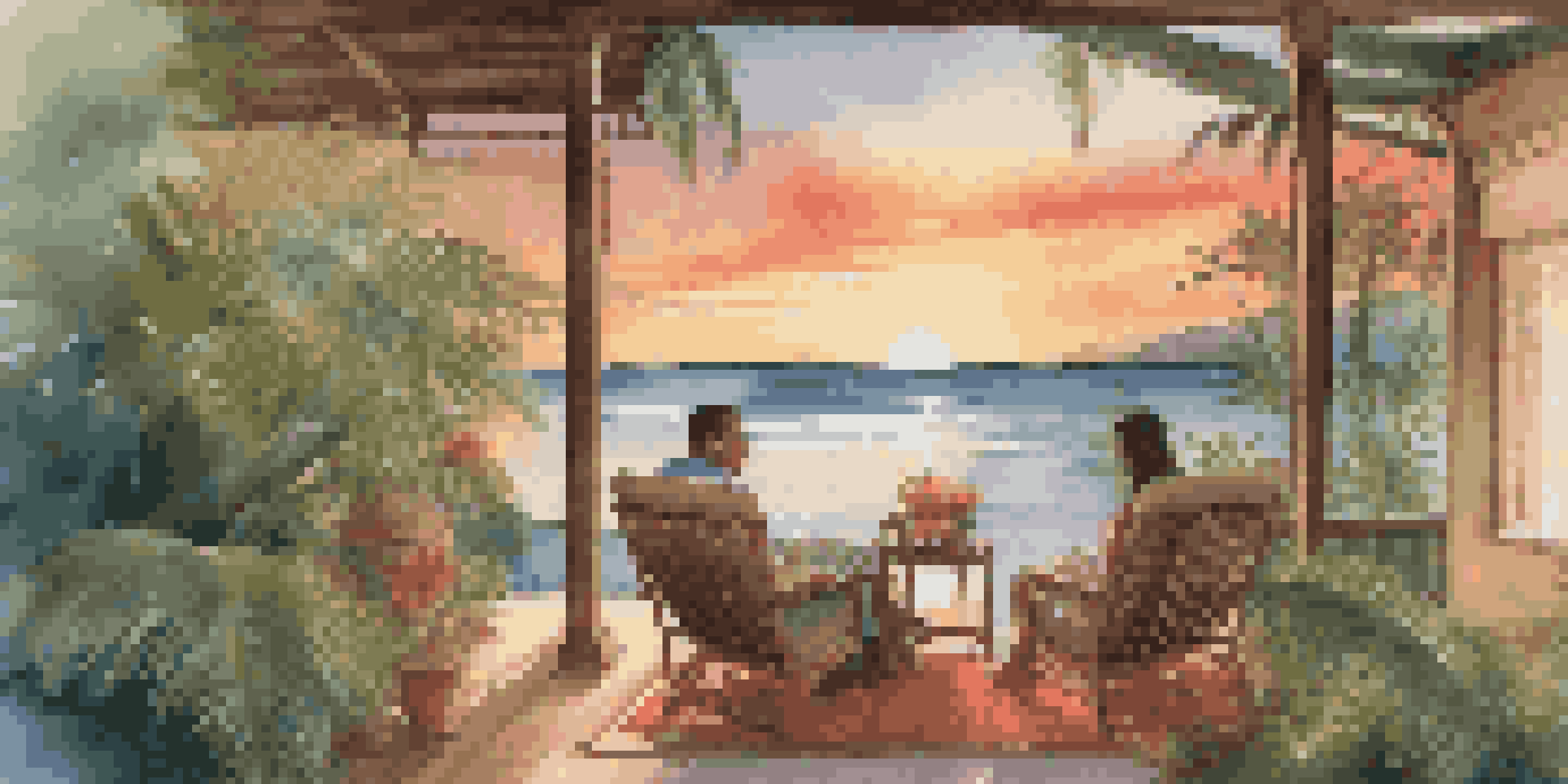A couple enjoying a romantic evening at a beachside villa during sunset, with a glass of wine and tropical plants around them.