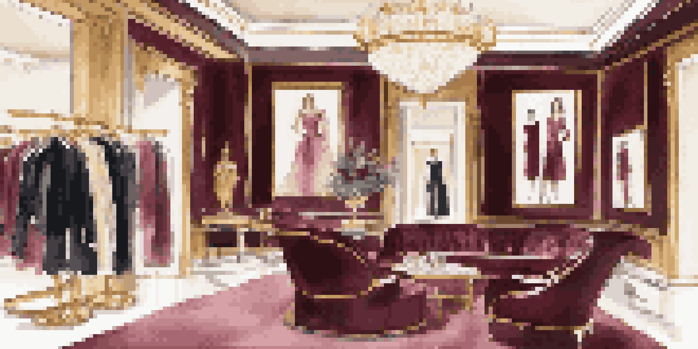 An elegant interior of a luxury fashion boutique showcasing designer clothing with marble flooring and soft lighting.