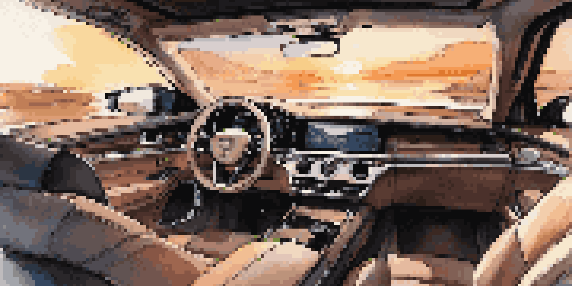 The interior of a luxury car featuring leather seats and high-tech displays illuminated by sunset light.