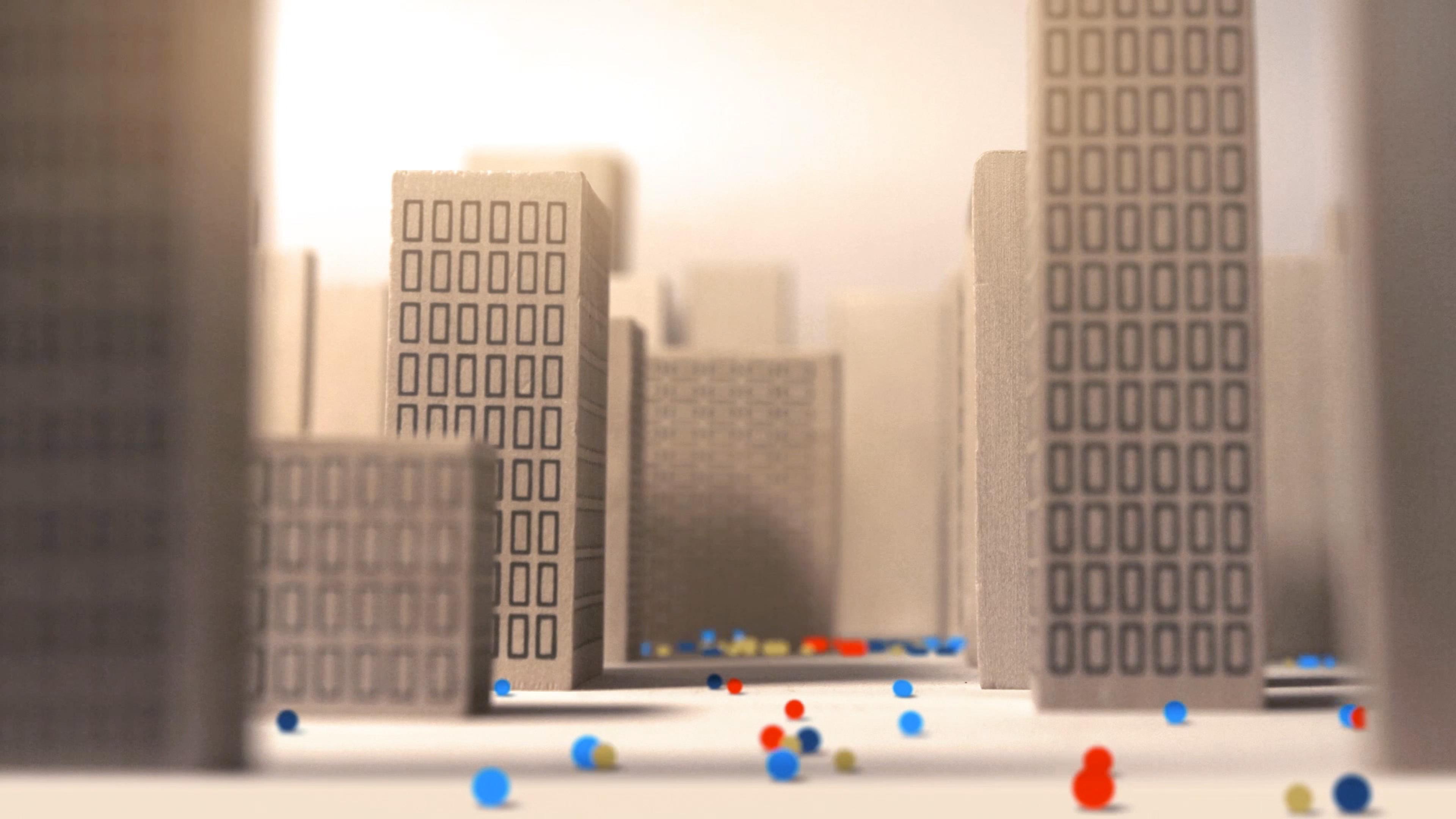 Animated colorful balls in a paper city landscape