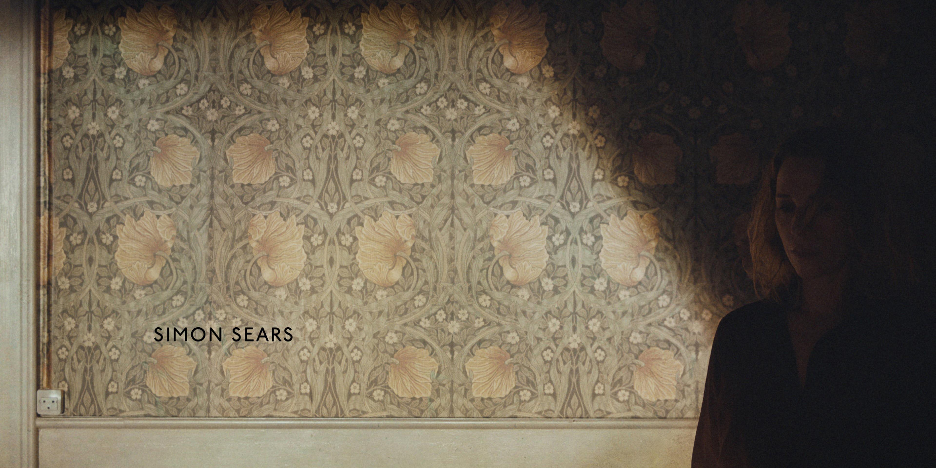 woman standing in front of wallpaper