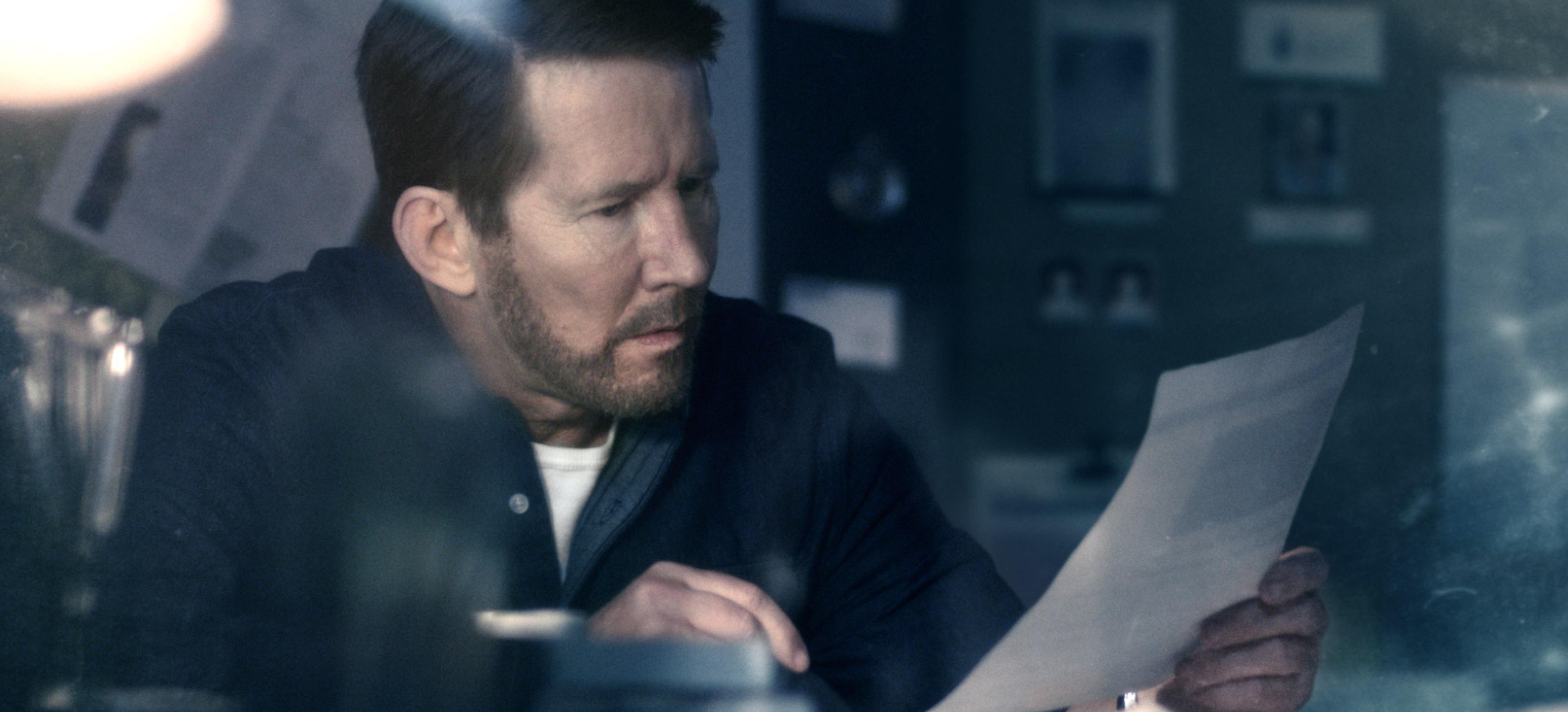 Man looking at paper