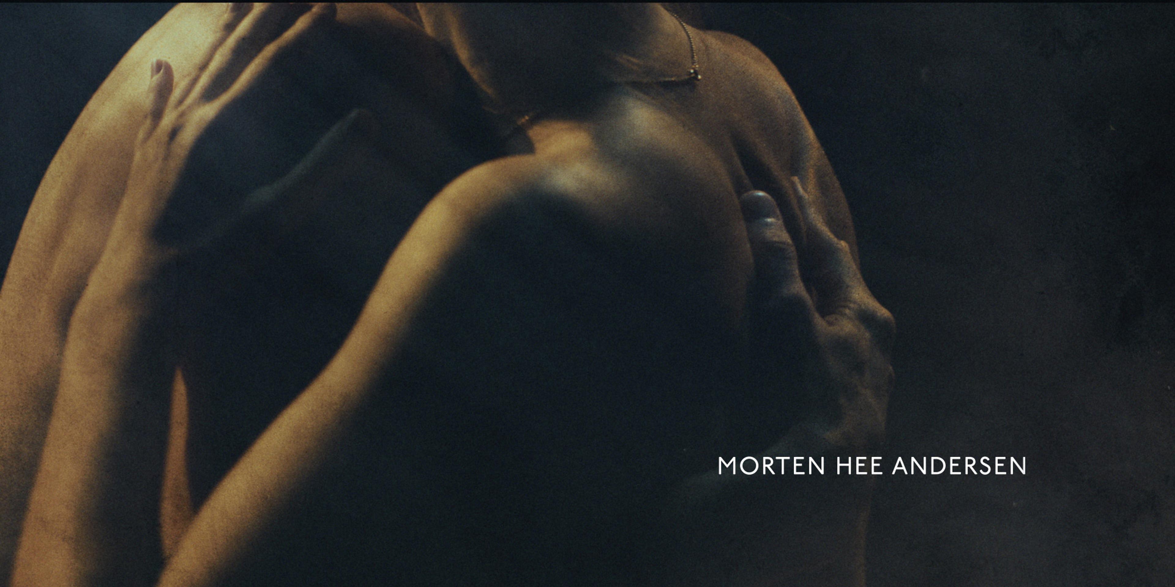 two naked people embracing in the dark