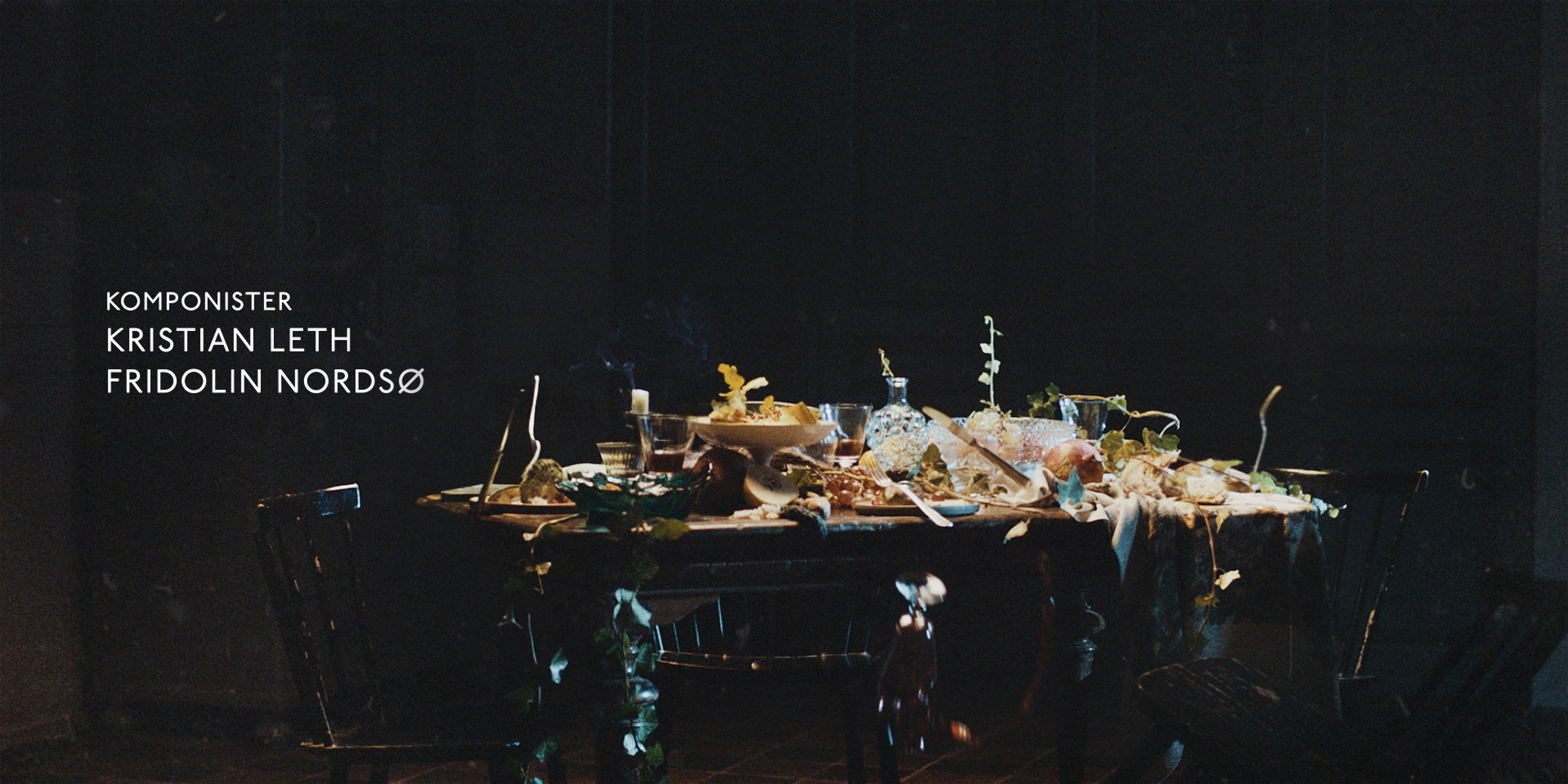 a dinner table overflowing with food in a dimly lit room