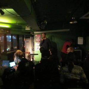 Matt in China. A picture of him performing at a bar-lounge in Beijing China, and a picture of him in front of the great wall.