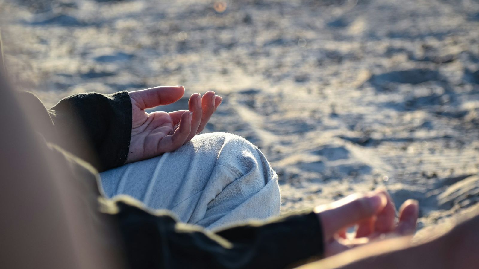a close up of a person laying in the sand