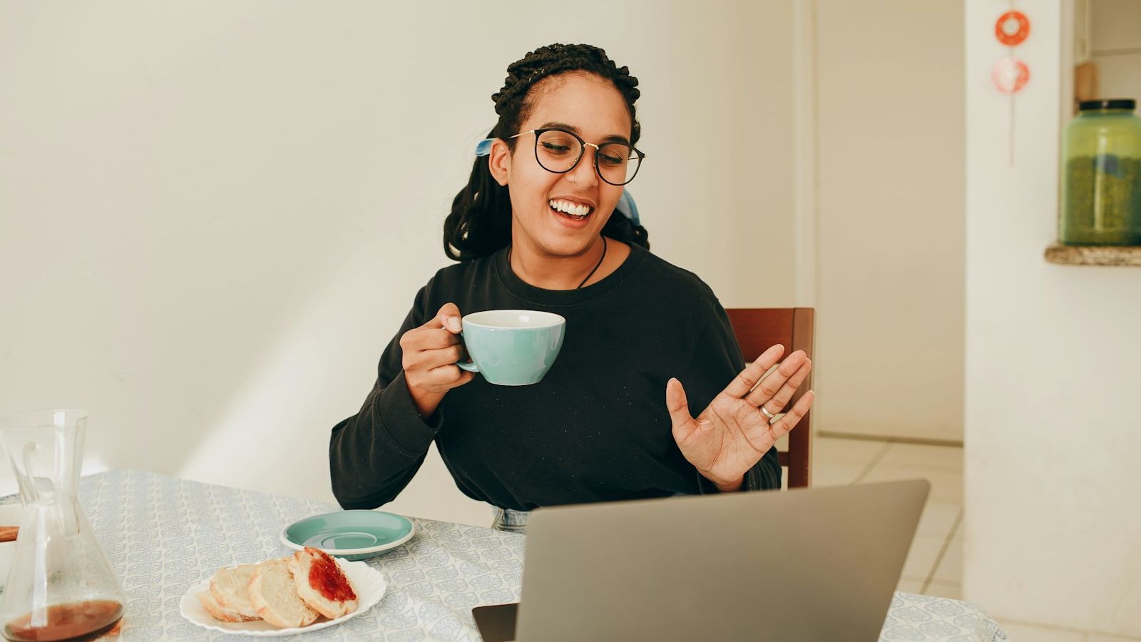 woman in black long sleeve shirt holding white ceramic mug