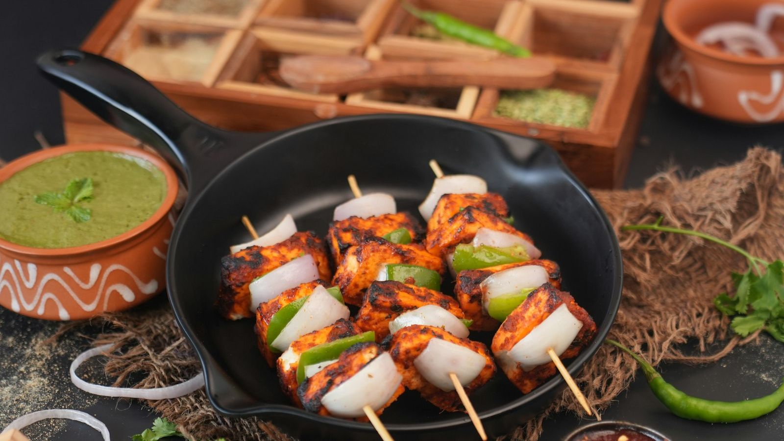 Chicken skewers cooked in a pan with spices