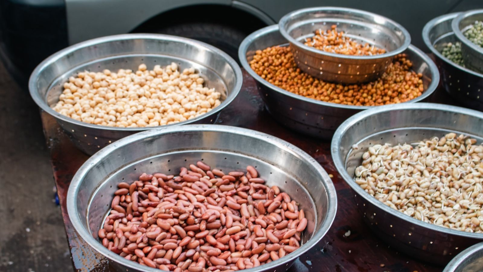 Bowls of assorted dried beans and legumes.