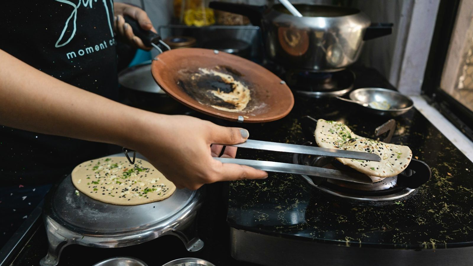 A person cooking food on top of a stove