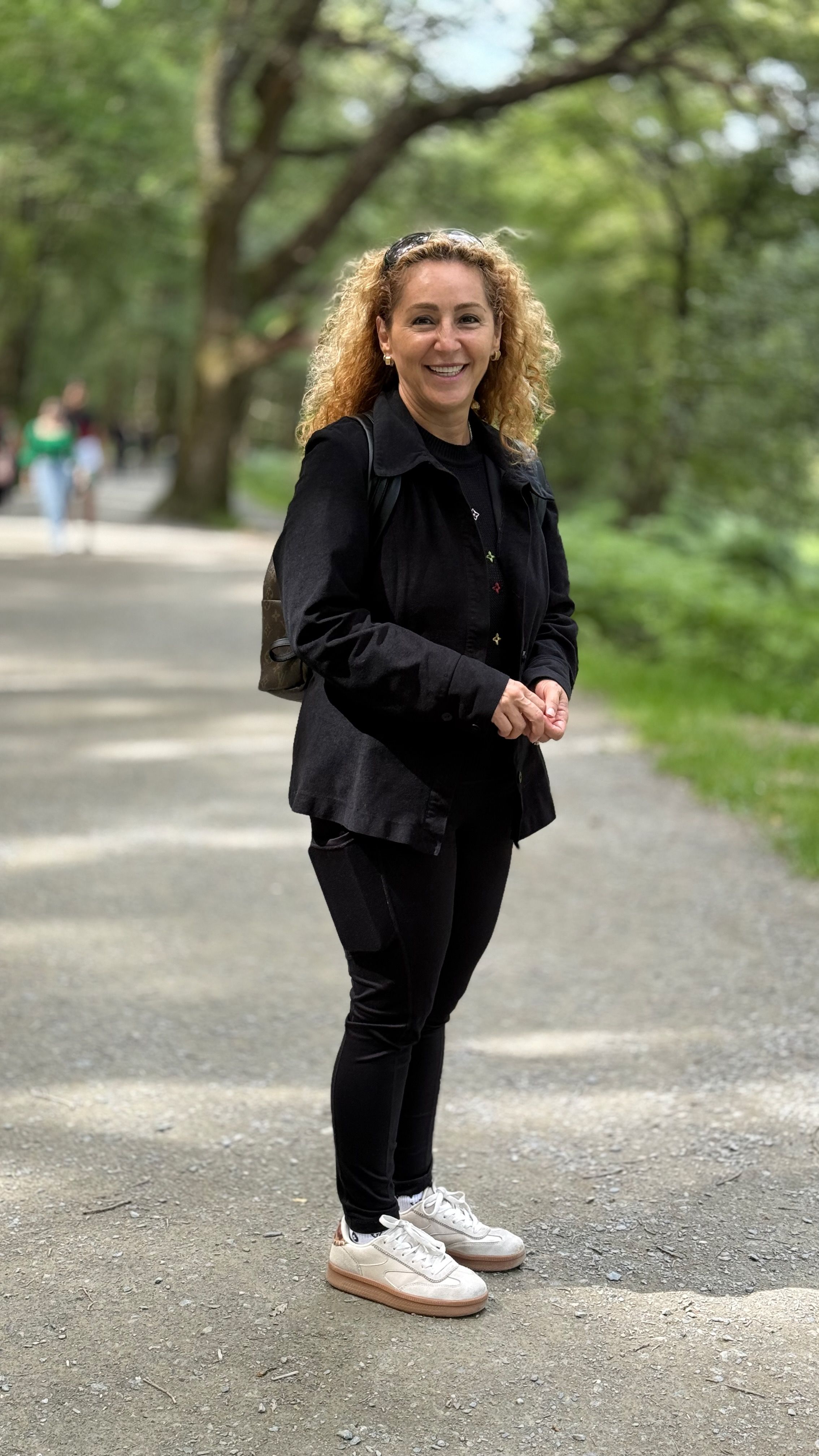 Claudia standing in an urban park