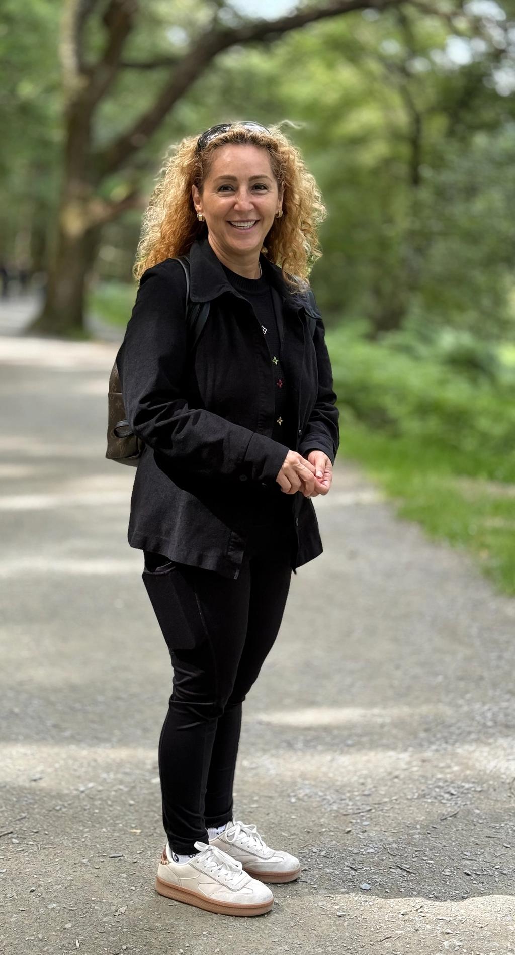 Claudia standing in an urban park