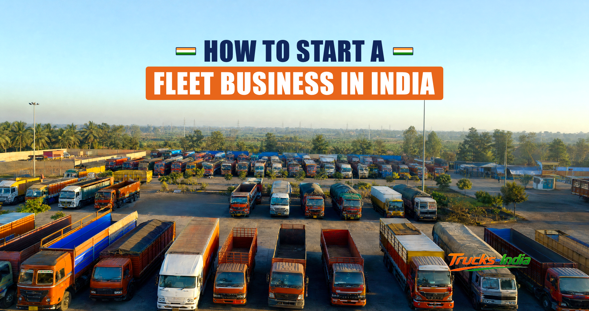 Fleet of commercial trucks parked in rows at an Indian yard