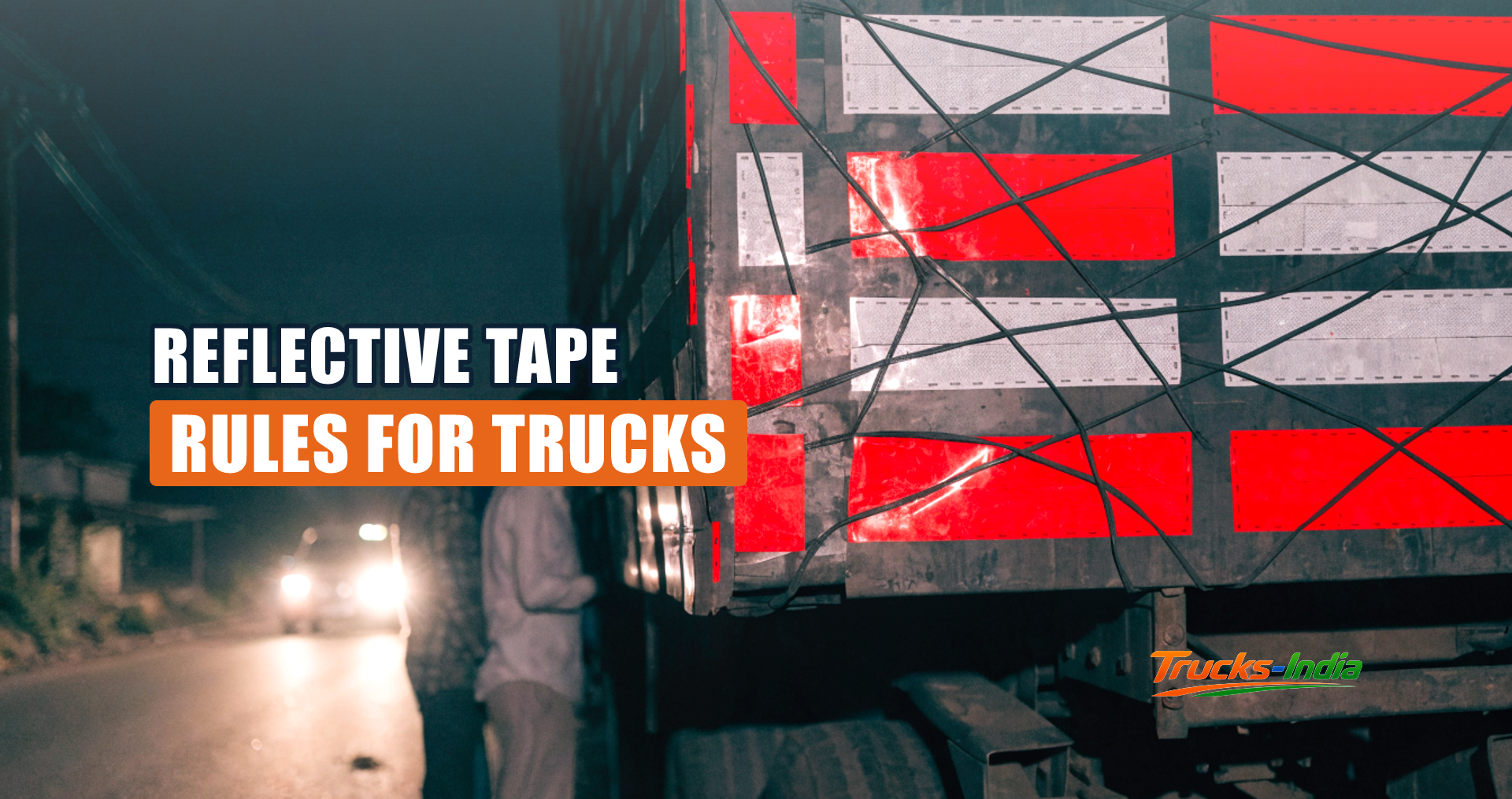 Red and white retro reflective tape on the rear of an Indian truck at night