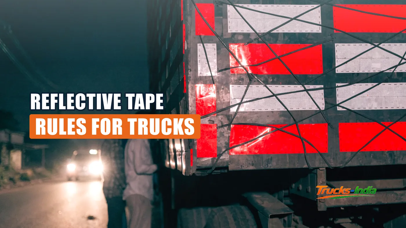 Red and white retro reflective tape on the rear of an Indian truck at night
