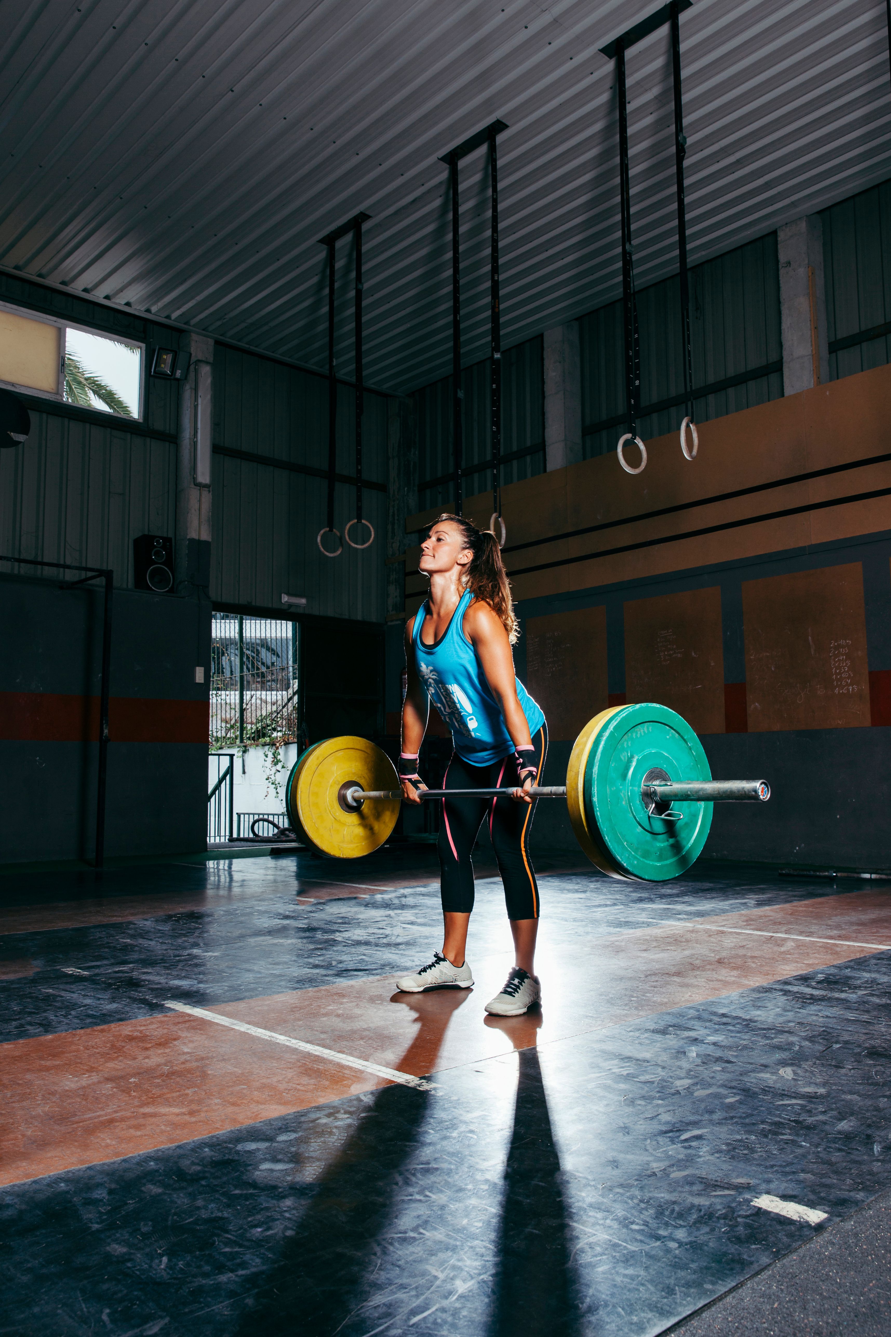 Sporty woman lifting barbell