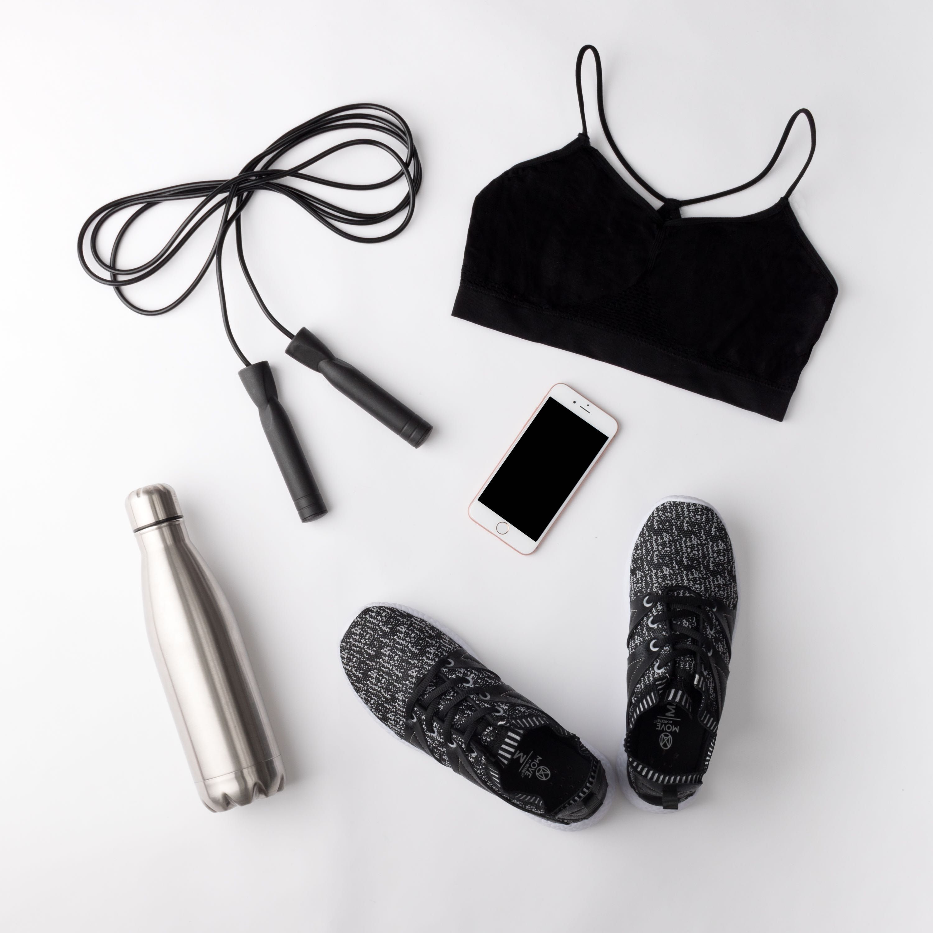 Black gym top, sneakers, bottle