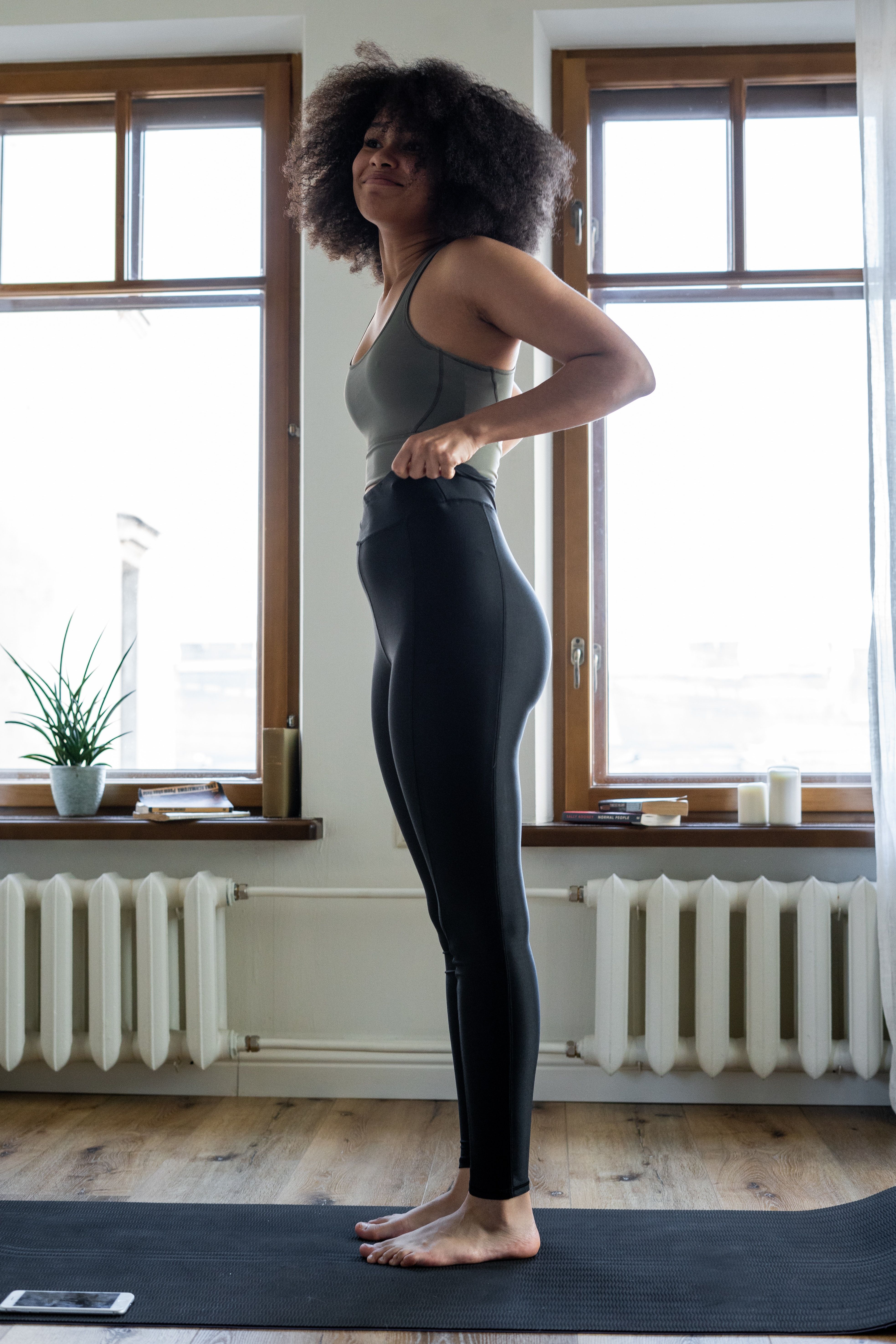 Woman wearing black leggings and olive top