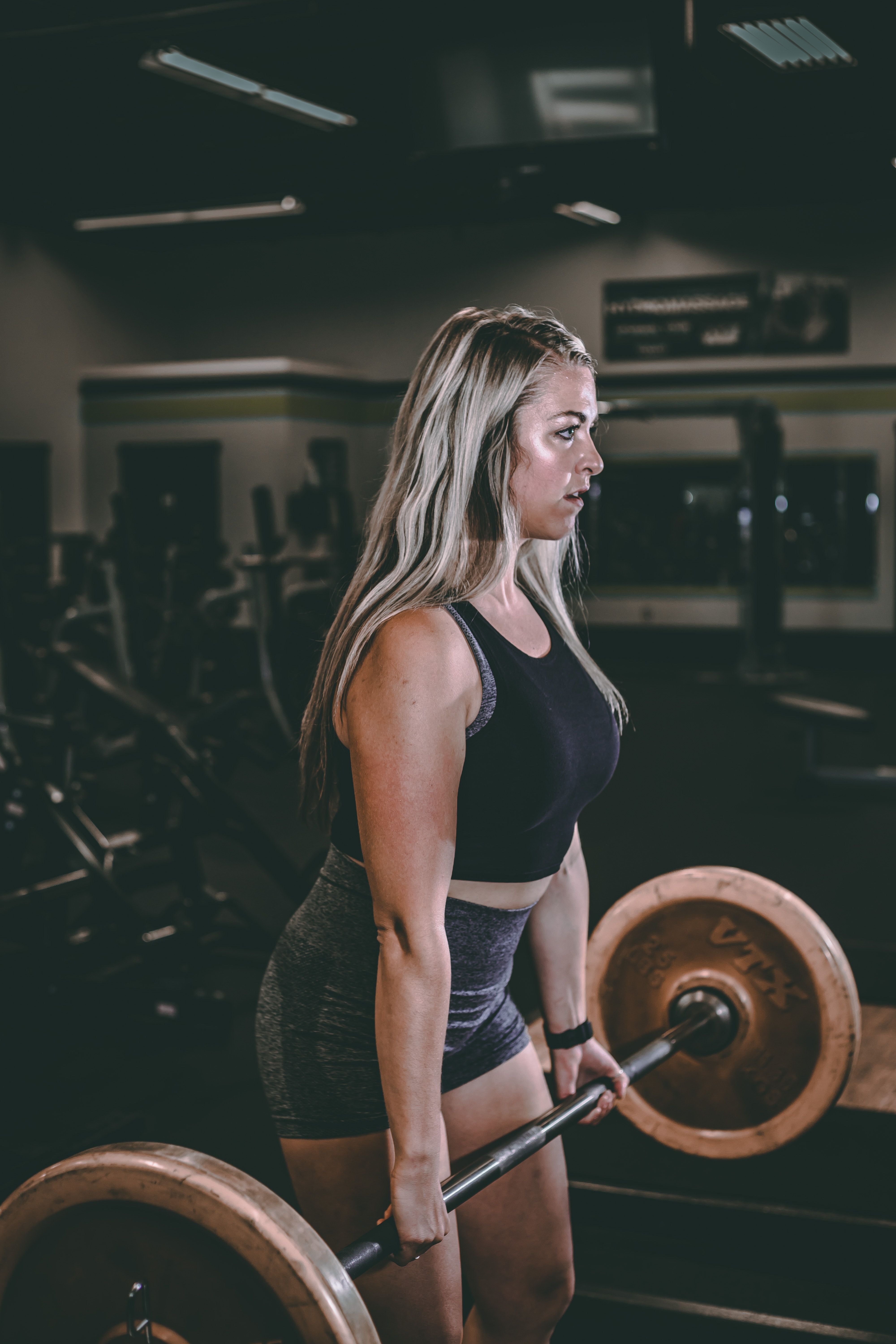 Blonde woman performs Romanian Deadlift