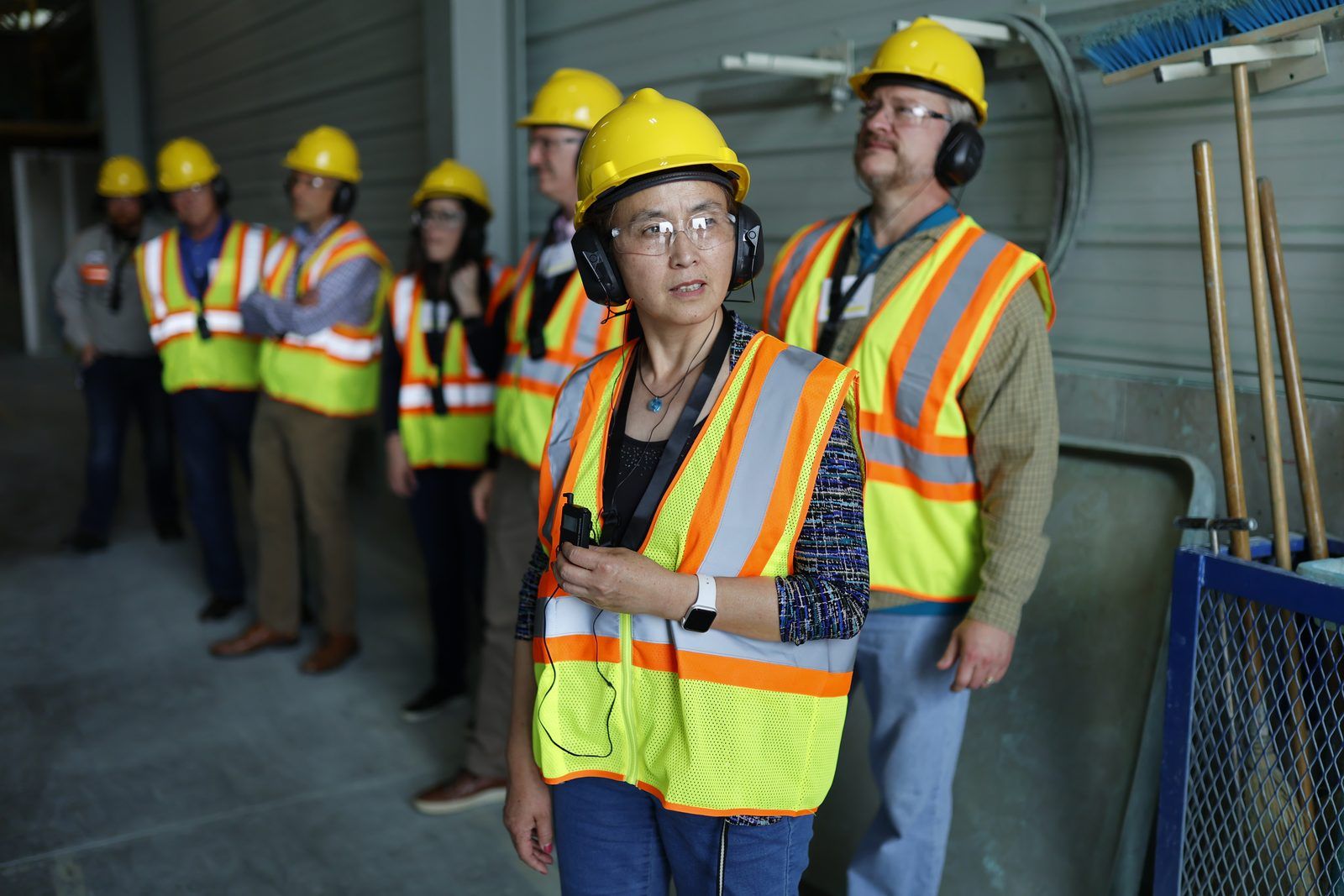 Team briefing on the plant floor in safety gear