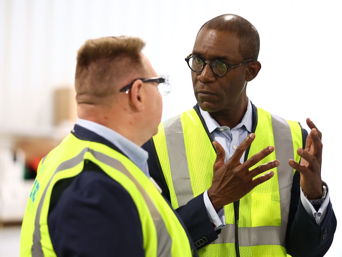 Two colleagues in hi-vis talking through a job on site