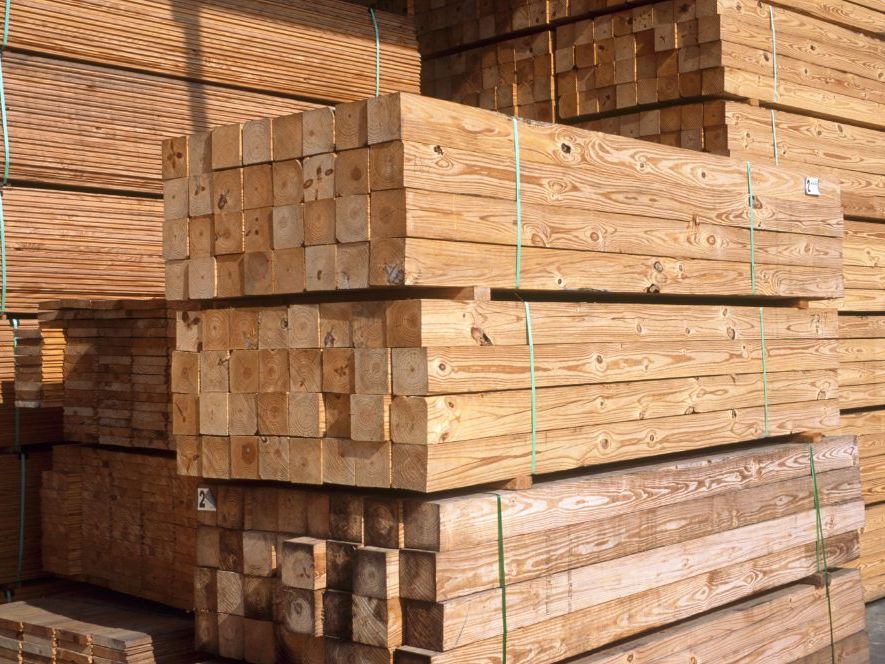 Treated lumber stacked at a production facility