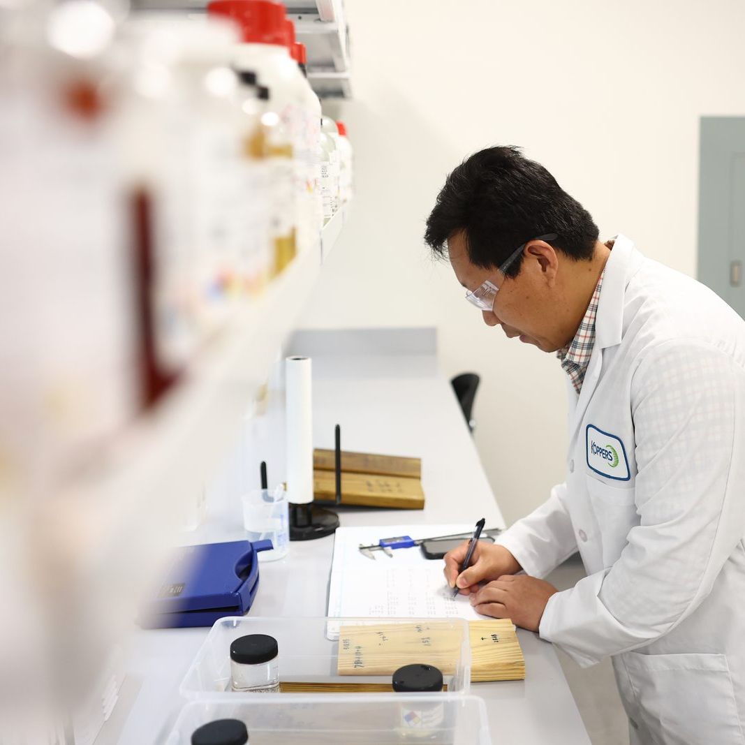 Koppers chemist recording test results at the lab bench