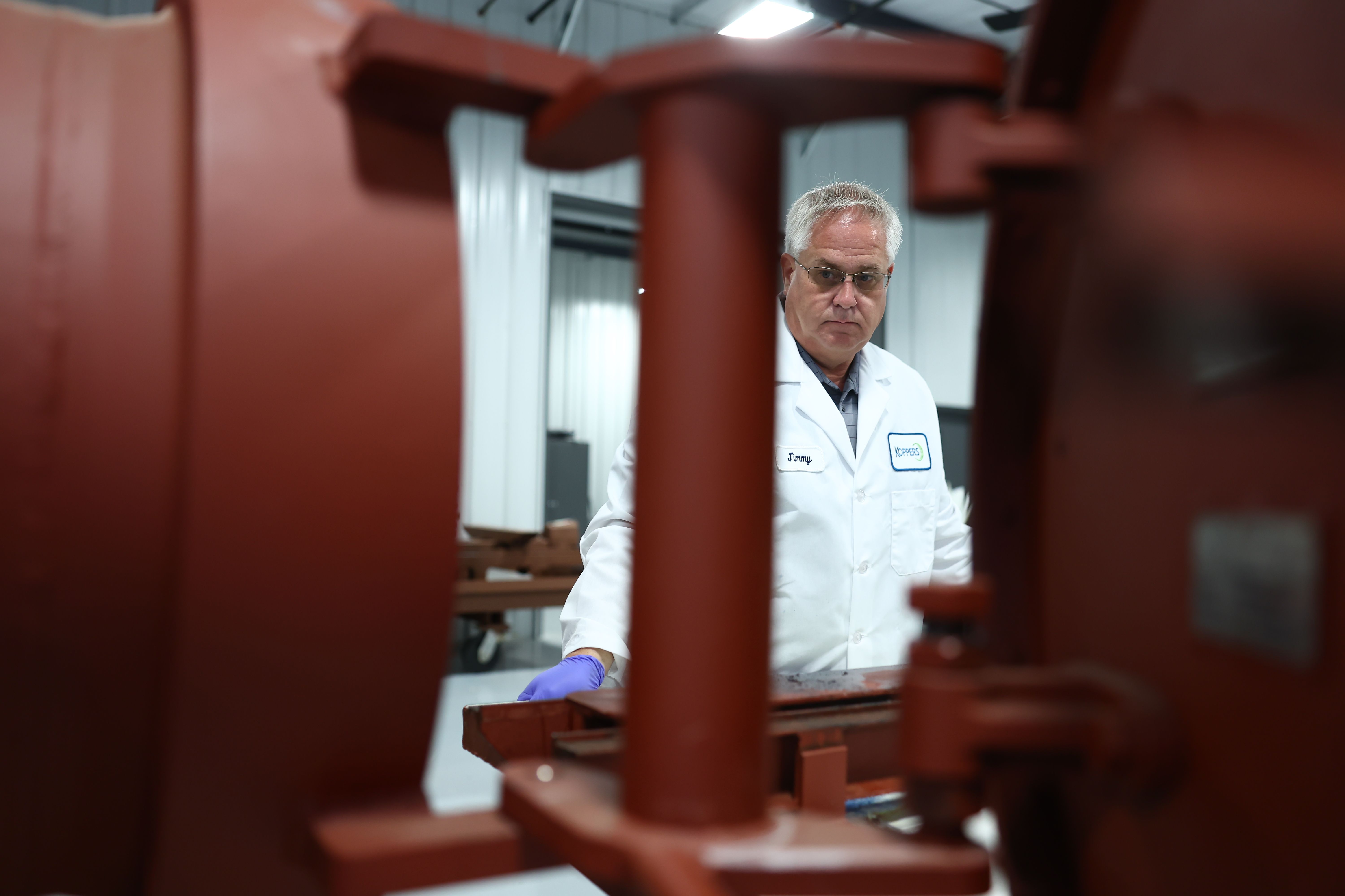 Koppers scientist in hi-vis and safety glasses on the plant floor