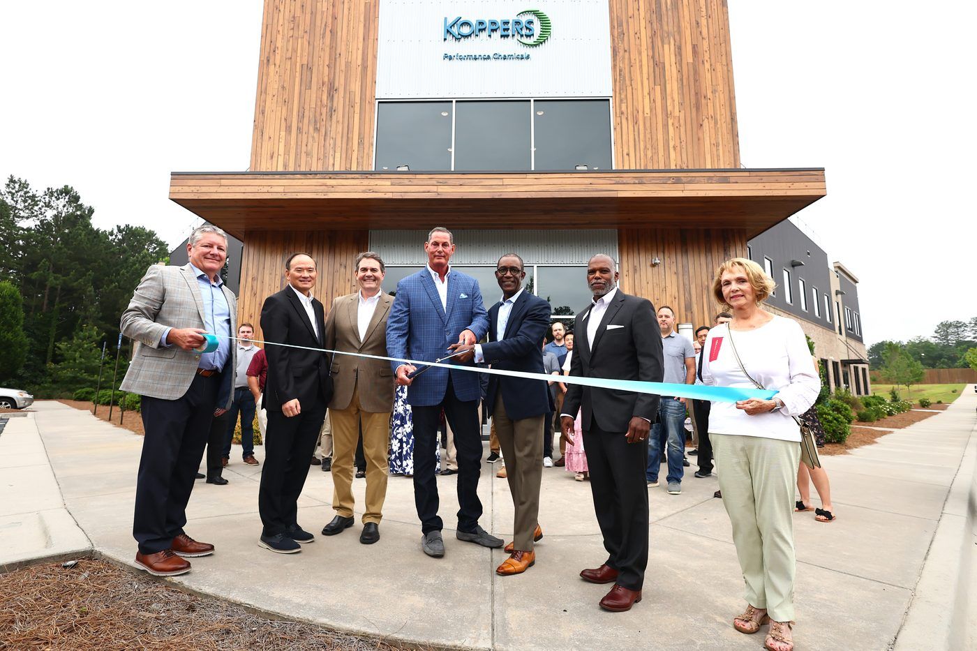 Ribbon-cutting outside the Koppers Performance Chemicals building