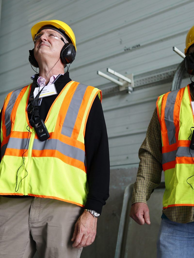 Plant staff in high-visibility gear on the production floor
