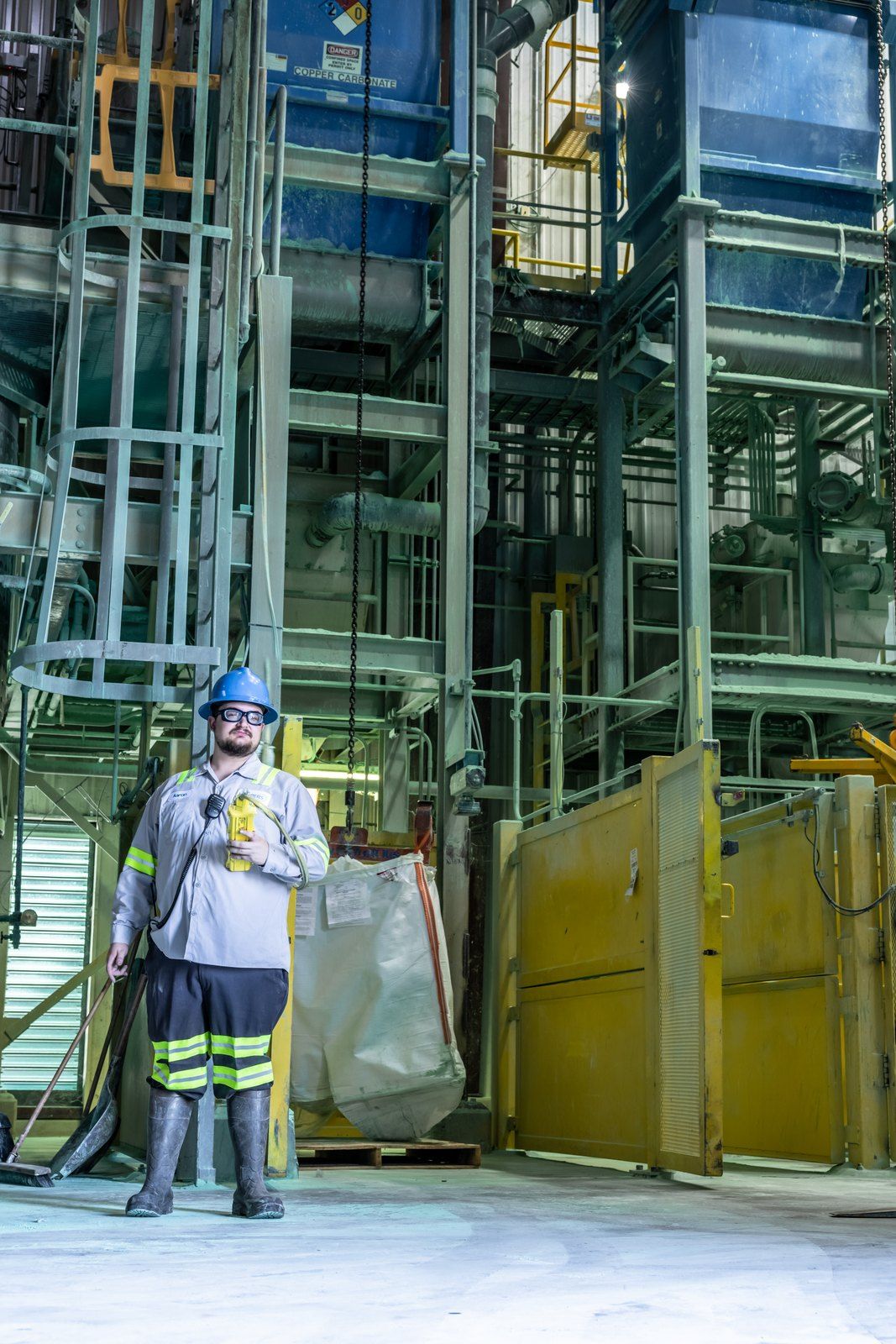 Operator working among tanks in the copper carbonate process area