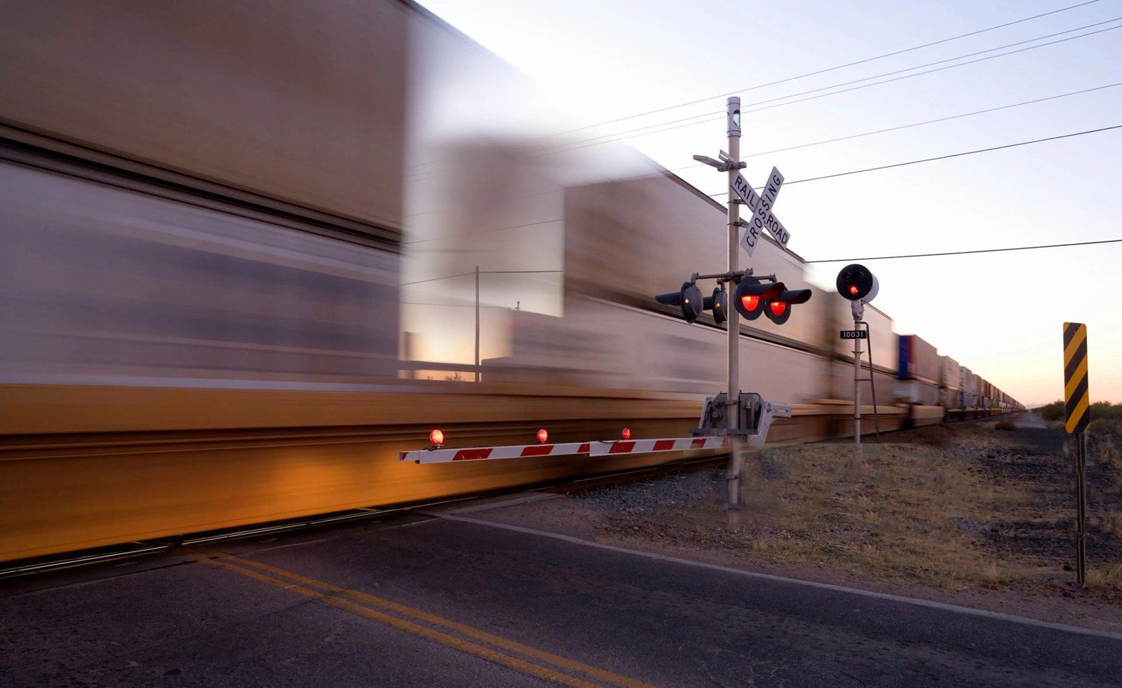 Freight train passing a rural crossing