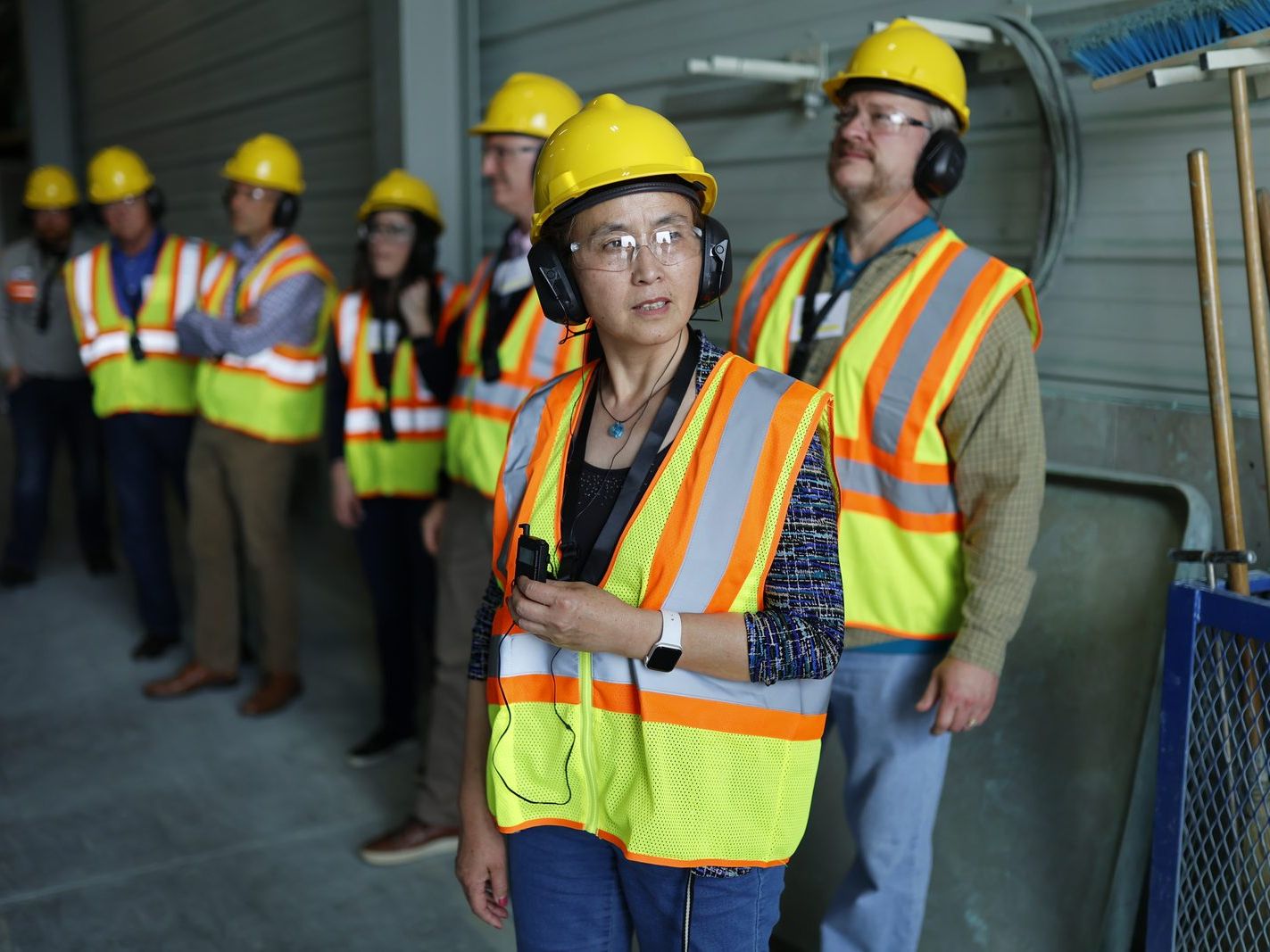 Team briefing on the plant floor in safety gear