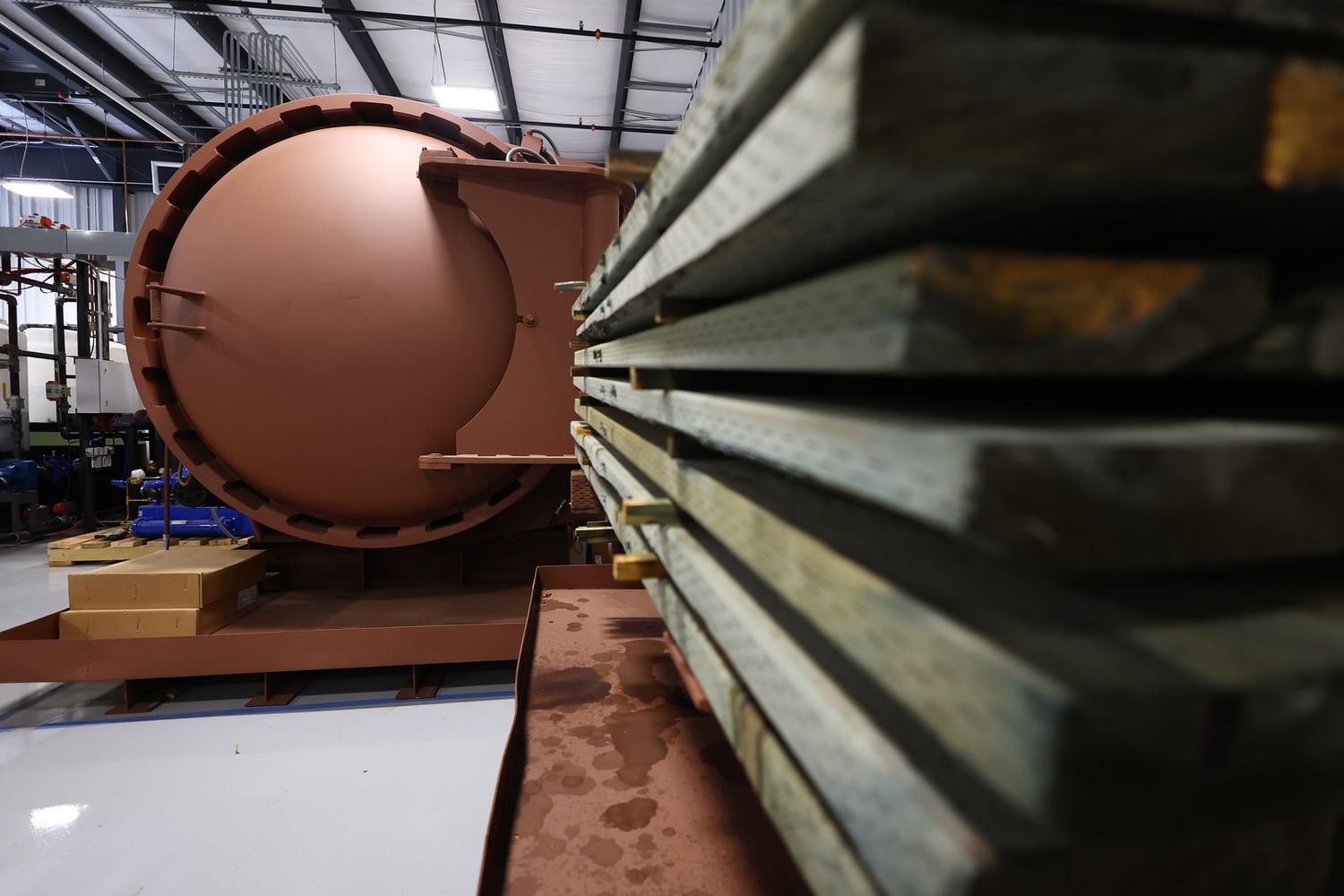Copper-toned treatment cylinder on the plant floor